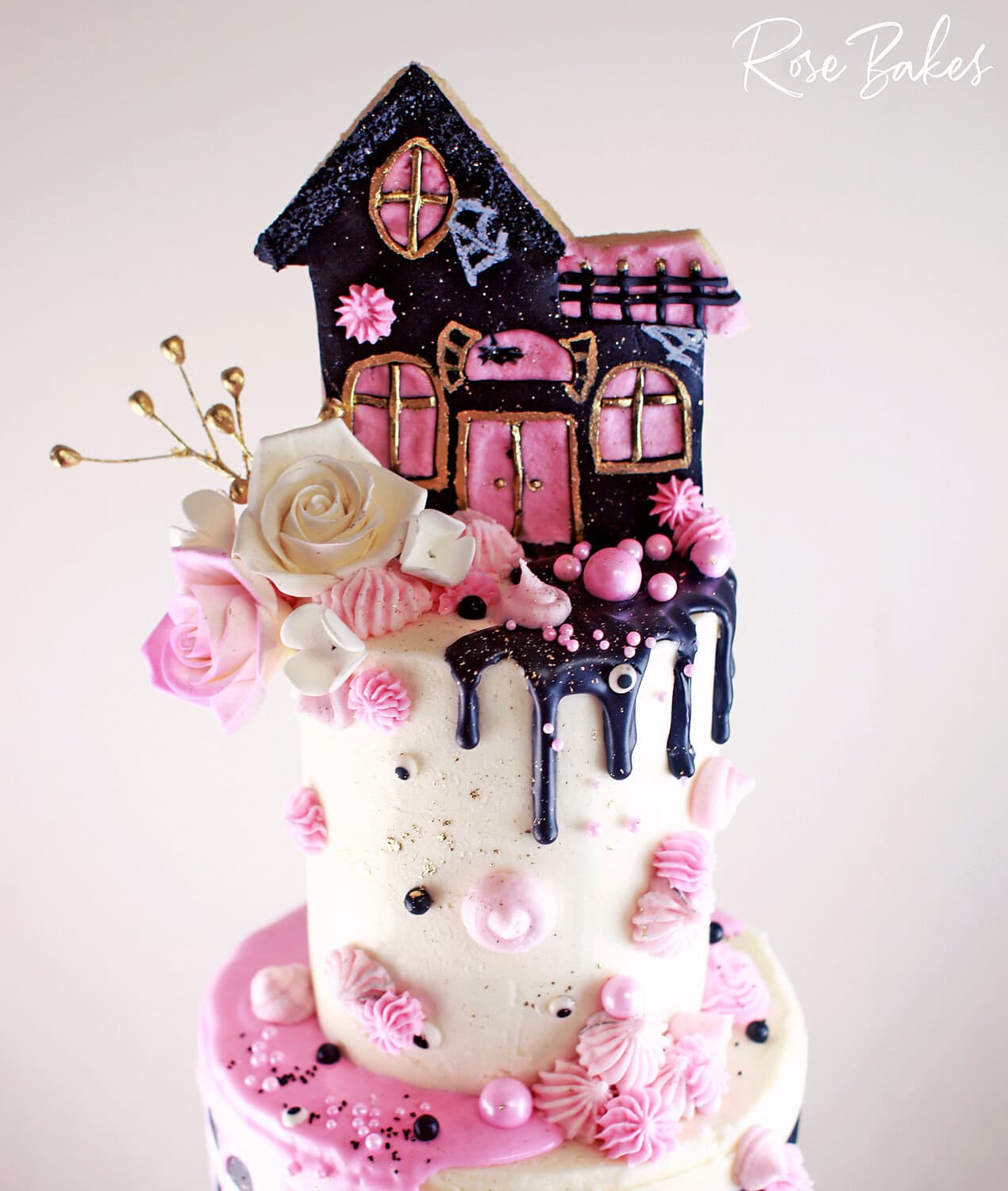 pink and black haunted house birthday cake