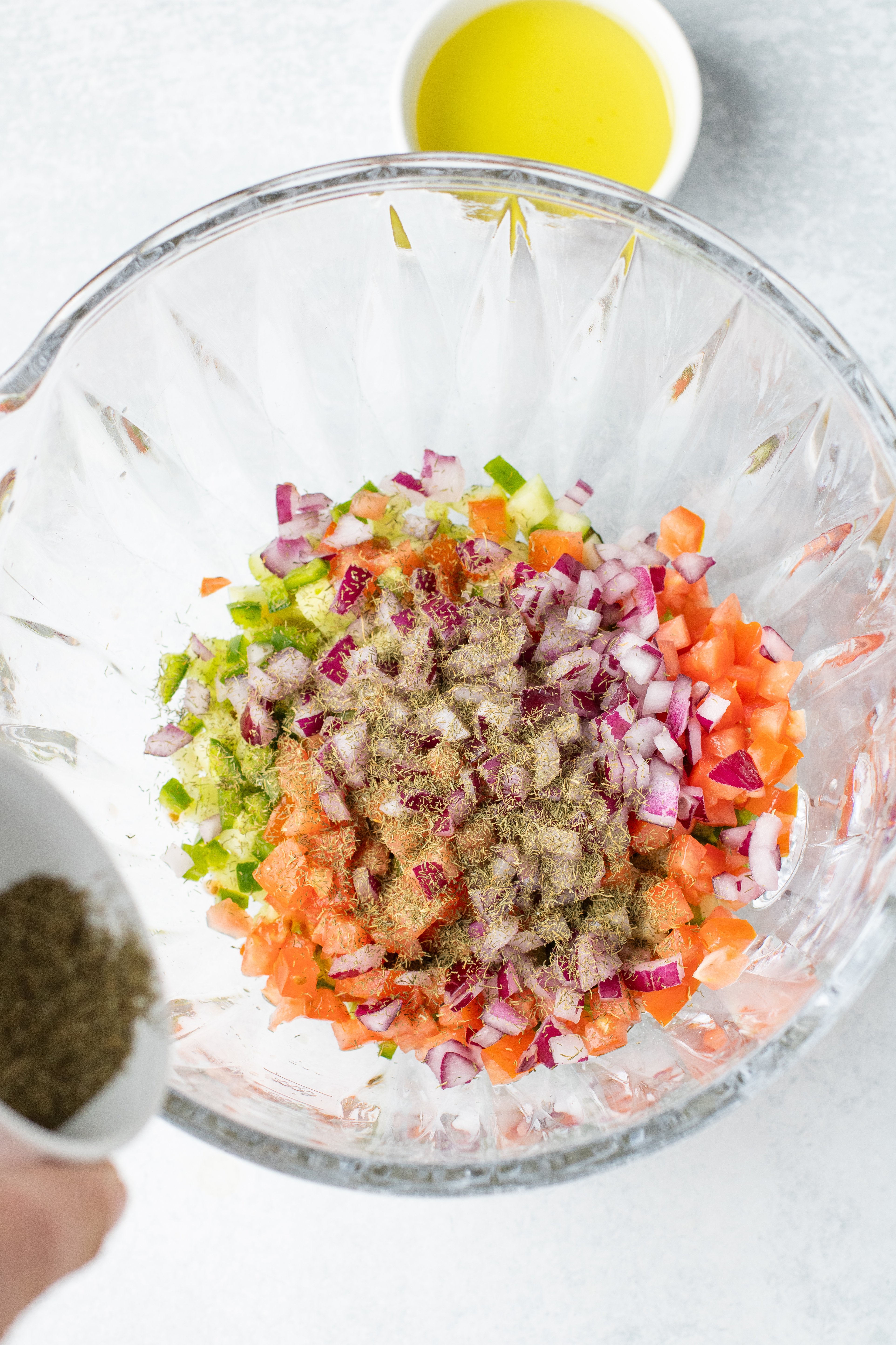 garlic powder and dill added to veggies for pickle de gallo