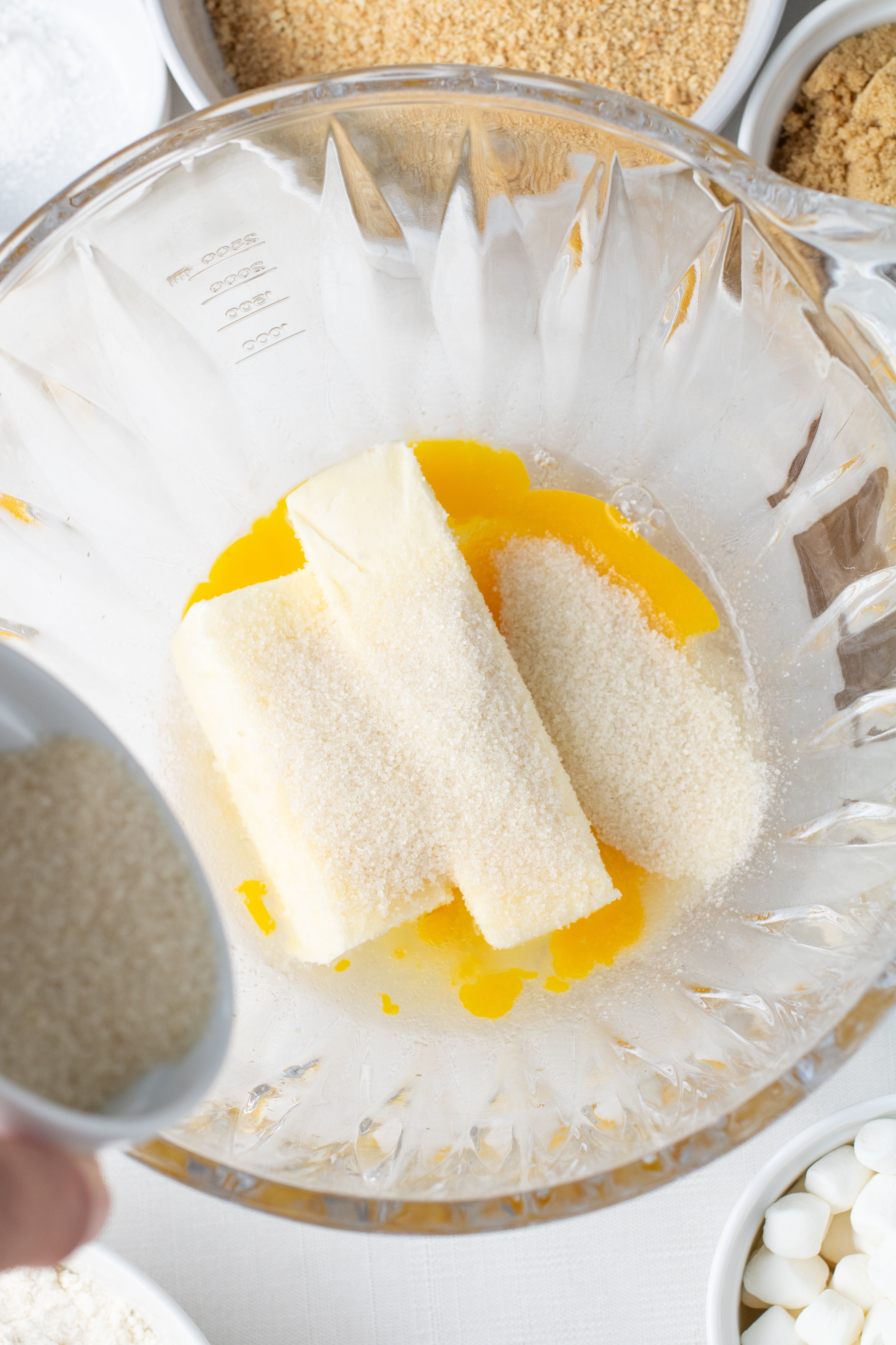 eggs and butter in a mixing bowl - adding white sugar and vanilla
