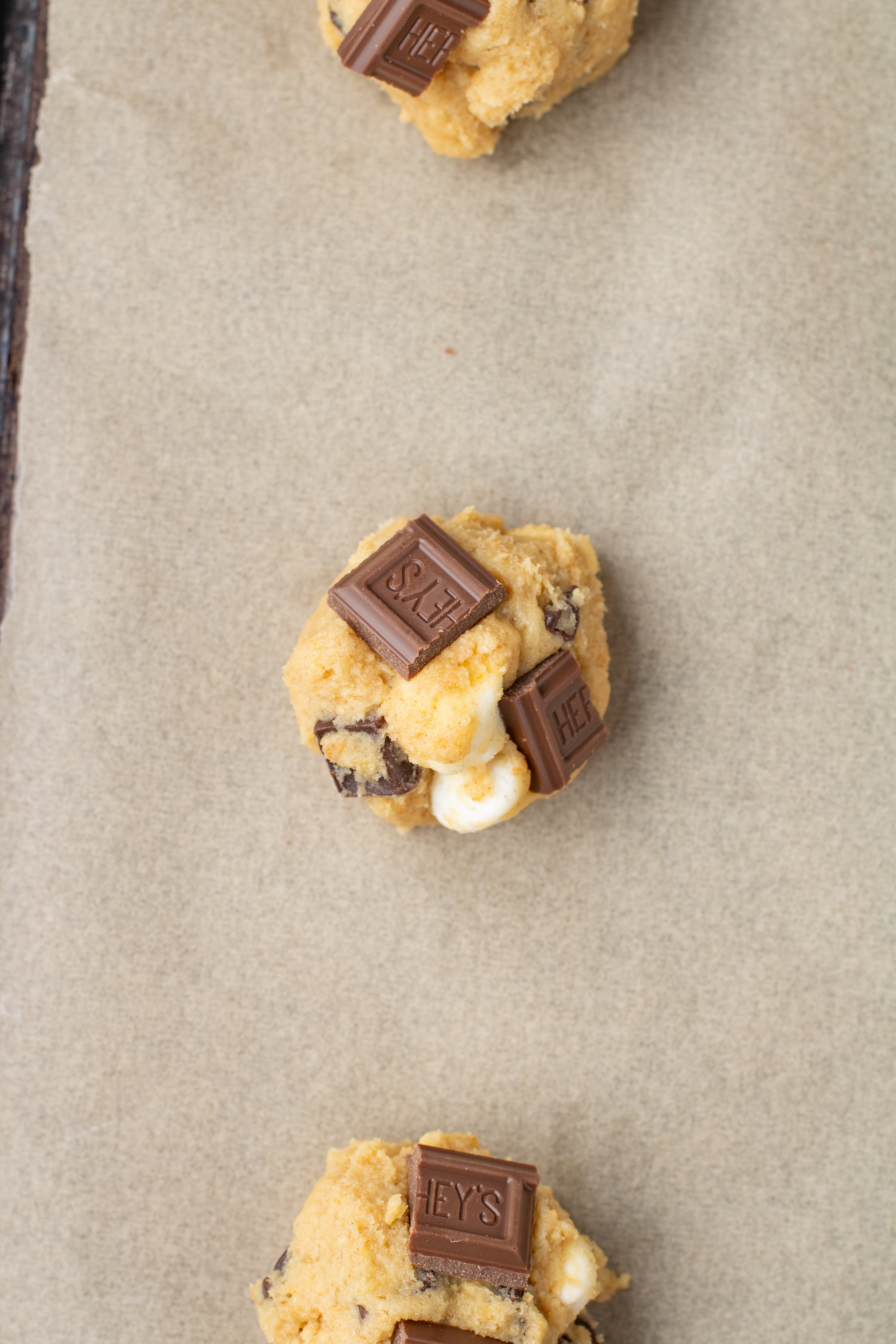 hershey bars broken and pressed into cookie dough balls