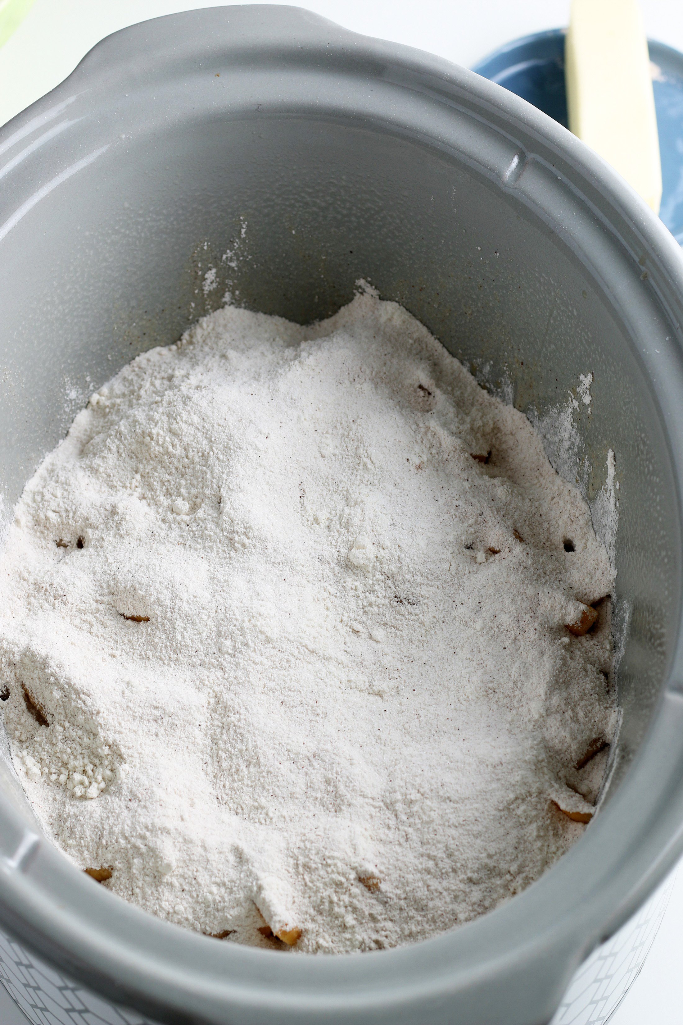 dry mixture poured over the peaches in the bottom of a slow cooker dish