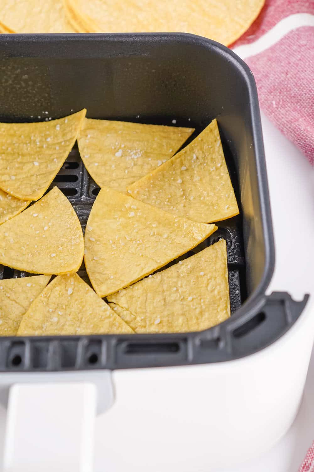 tortilla triangles in air fryer with coarse salt added