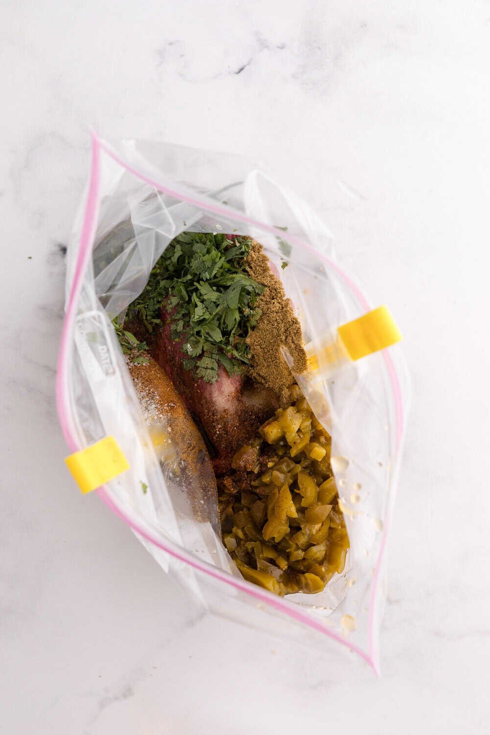 carne asada marinade ingredients in ziploc bag - shaken up to coat the steak