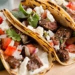 carne asada tacos on a cutting board
