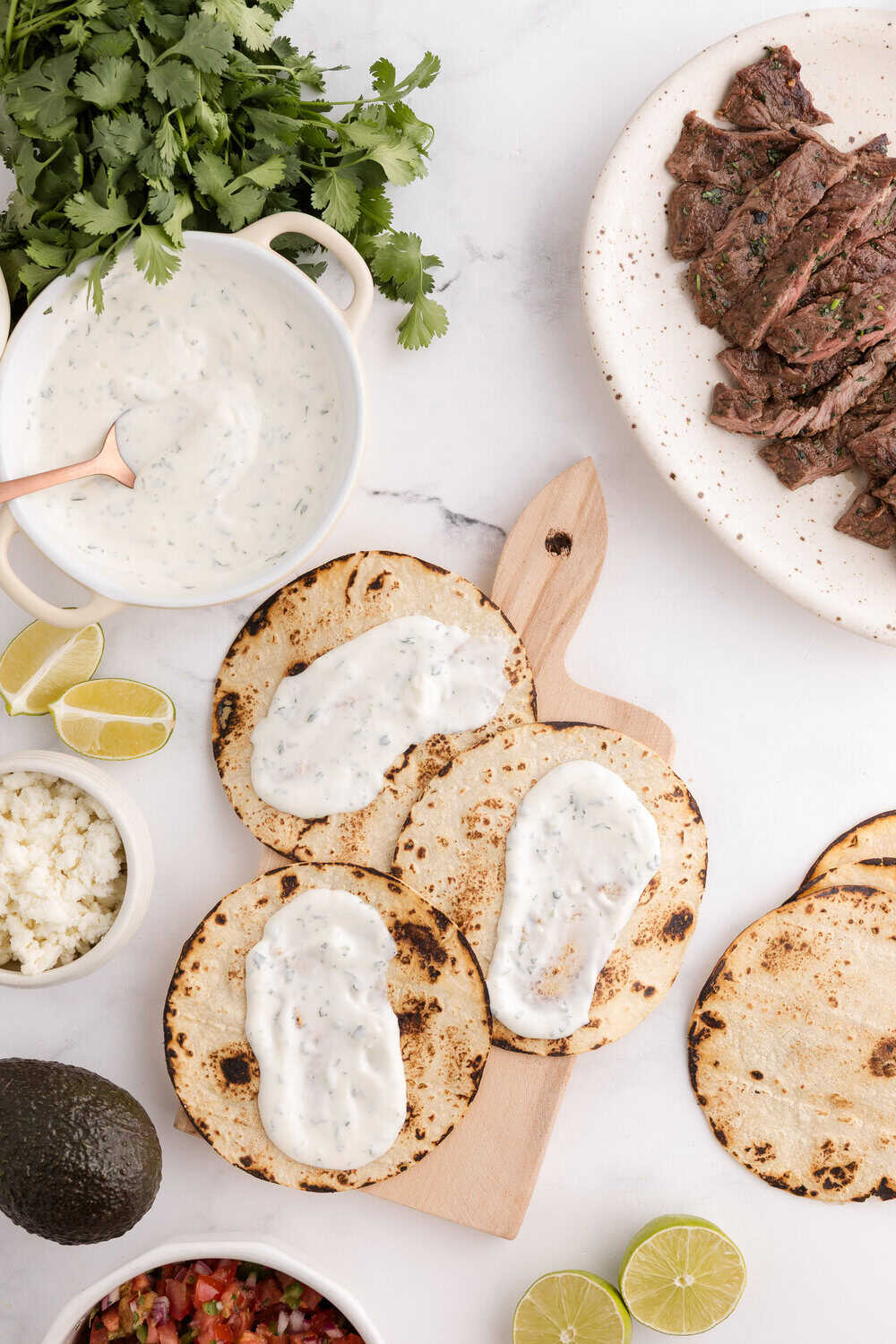 Cilantro Garlic Lime Crema spread on warm corn tortillas