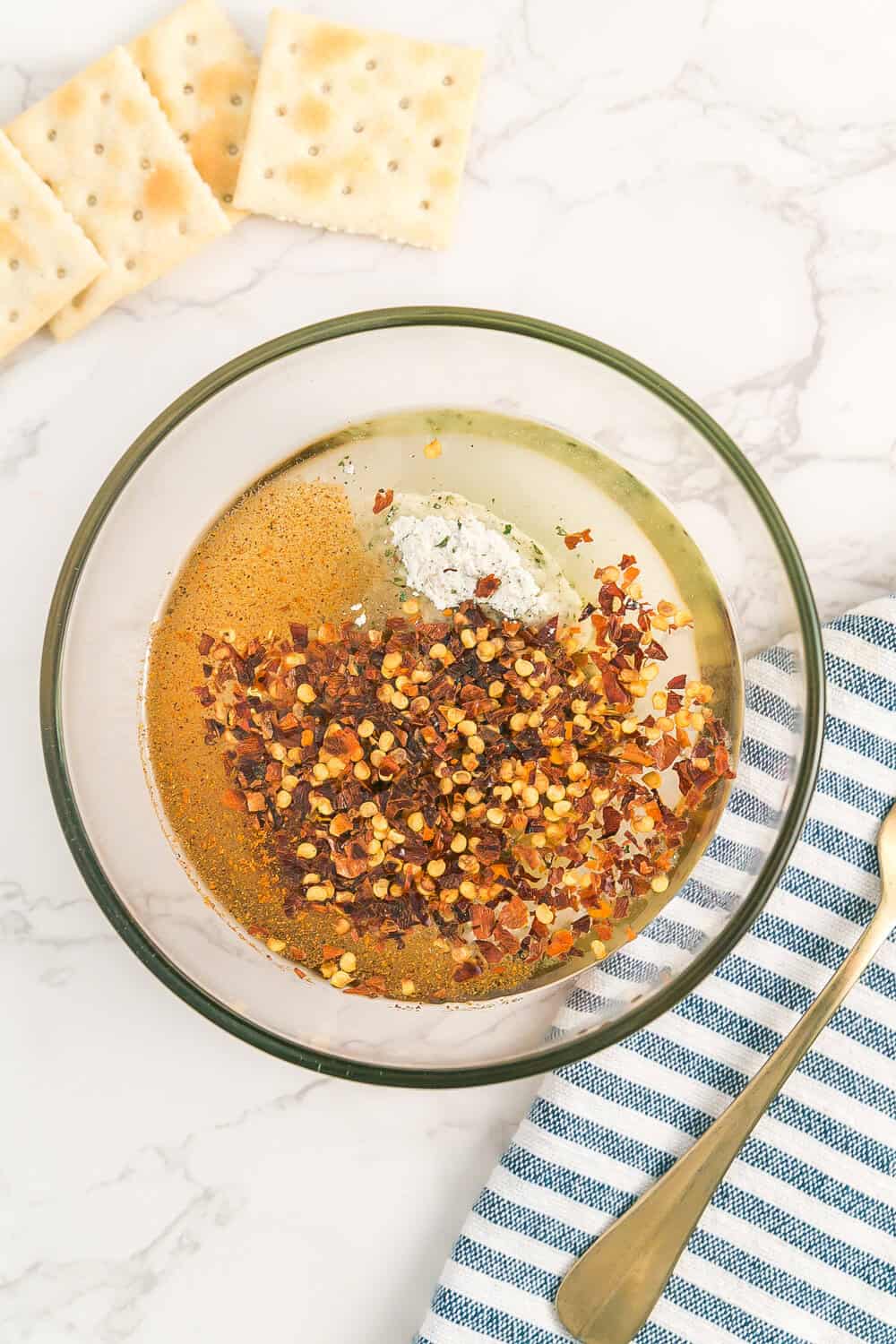 seasoning mix ingredients in clear mixing bowl