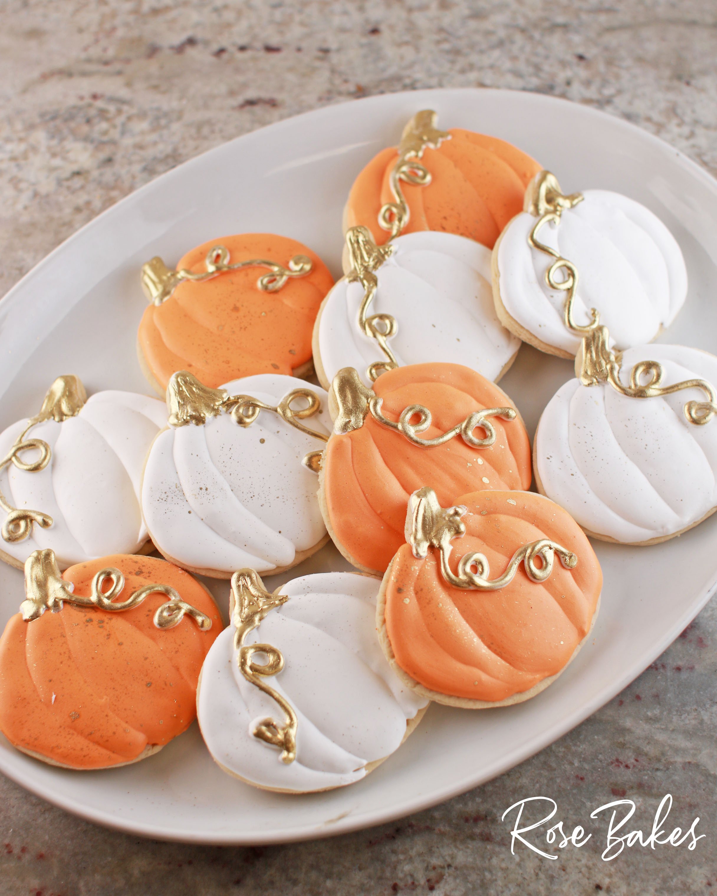 orange and white pumpkin cookies with gold highlights