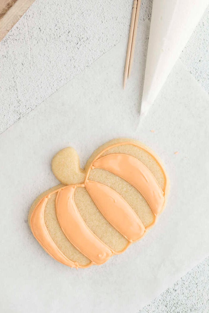 every other section of the pumpkin cookie filled with flood icing