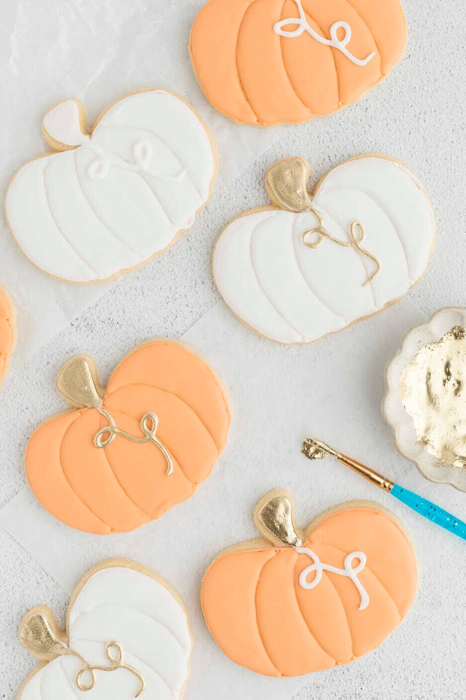 piping royal icing onto stems and painting gold