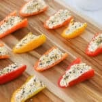 stuffed mini peppers on a cutting board
