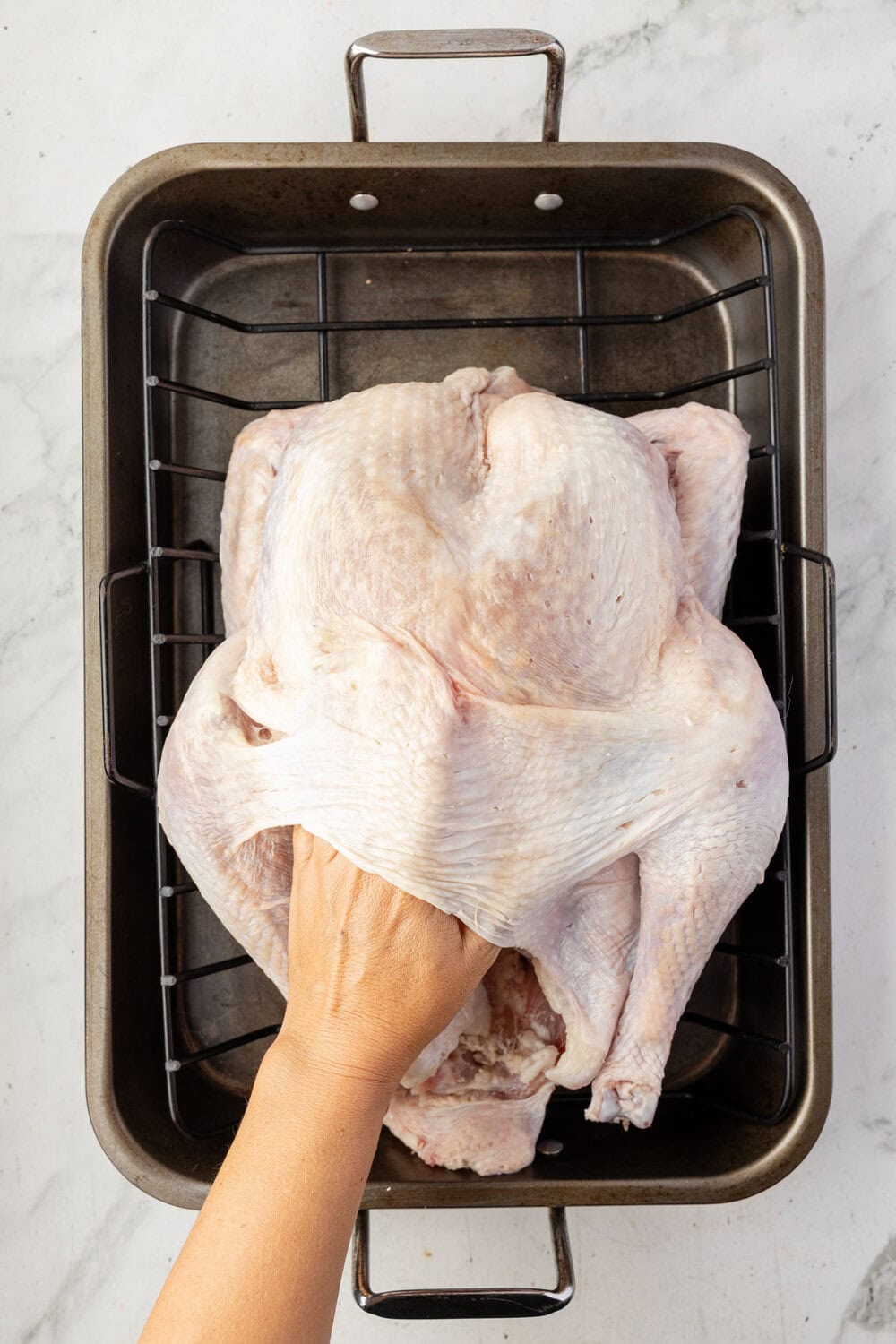 hand between bird and skin to make a pocket for the butter cajun rub