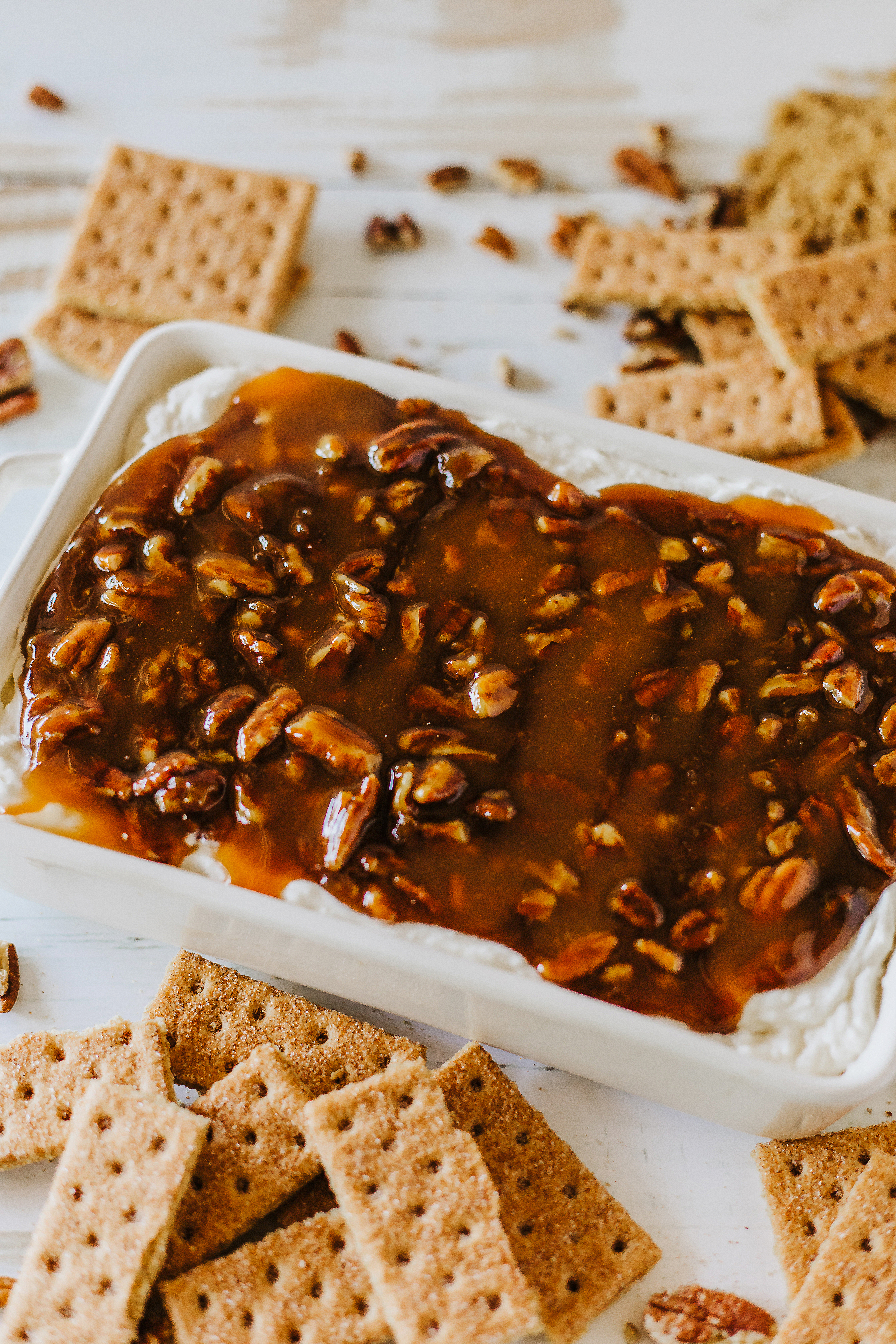 pecan pie dip in rectangle dish with cinnamon graham crackers
