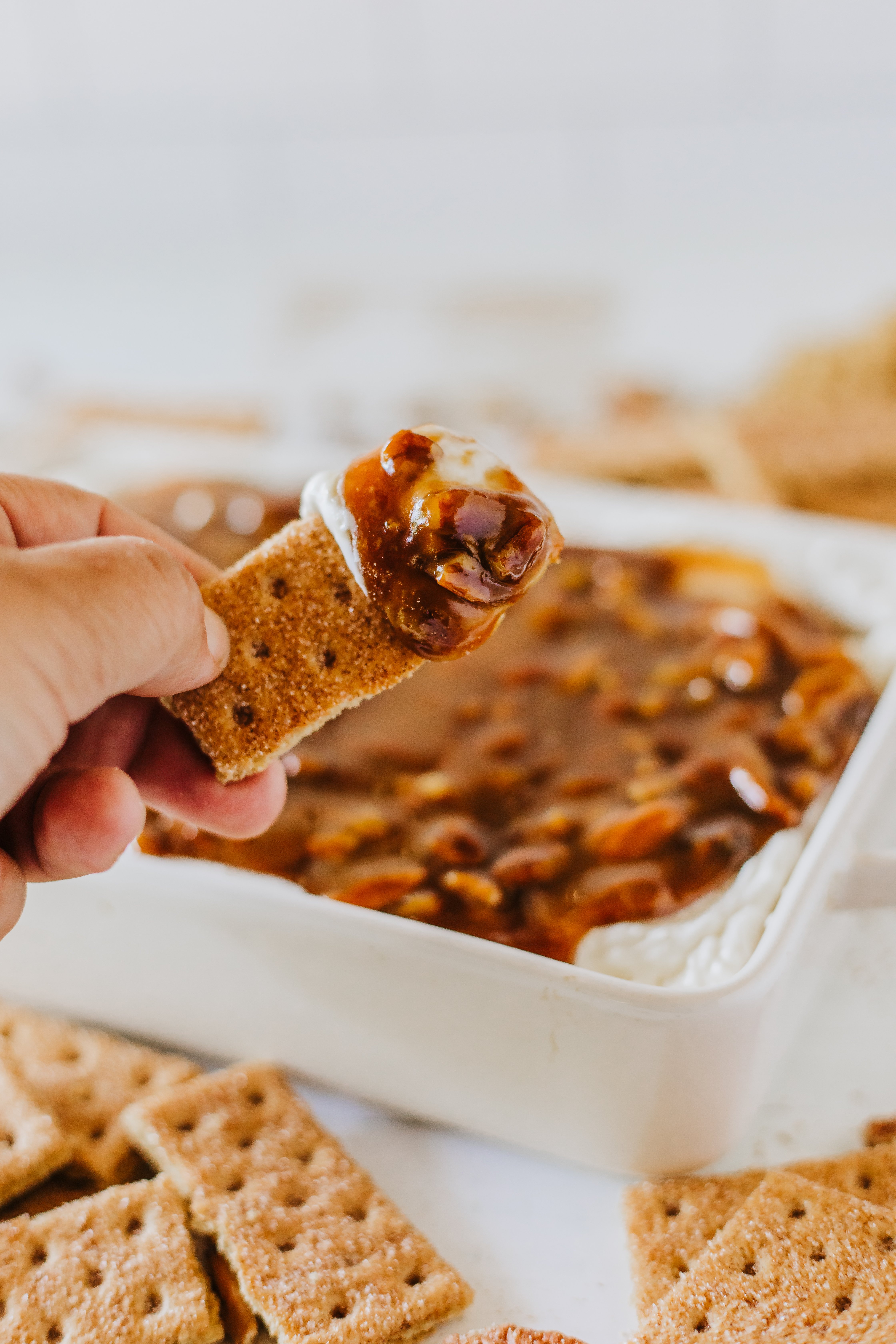 cinnamon graham cracker tha has been dipped into pecan pie dip