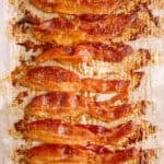 baked bacon on a baking sheet for the blog post "how to cook bacon in the oven"