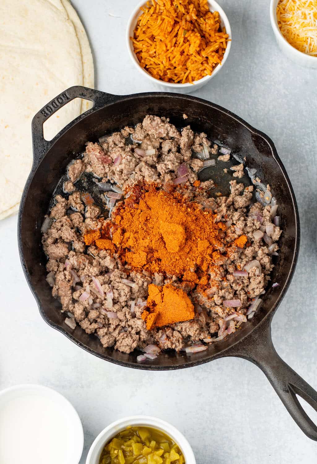 cooked ground beef and onions with taco seasoning