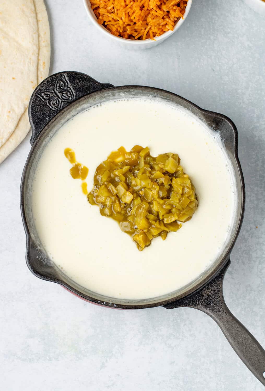 green chiles added to cheese sauce for mexican queso dip