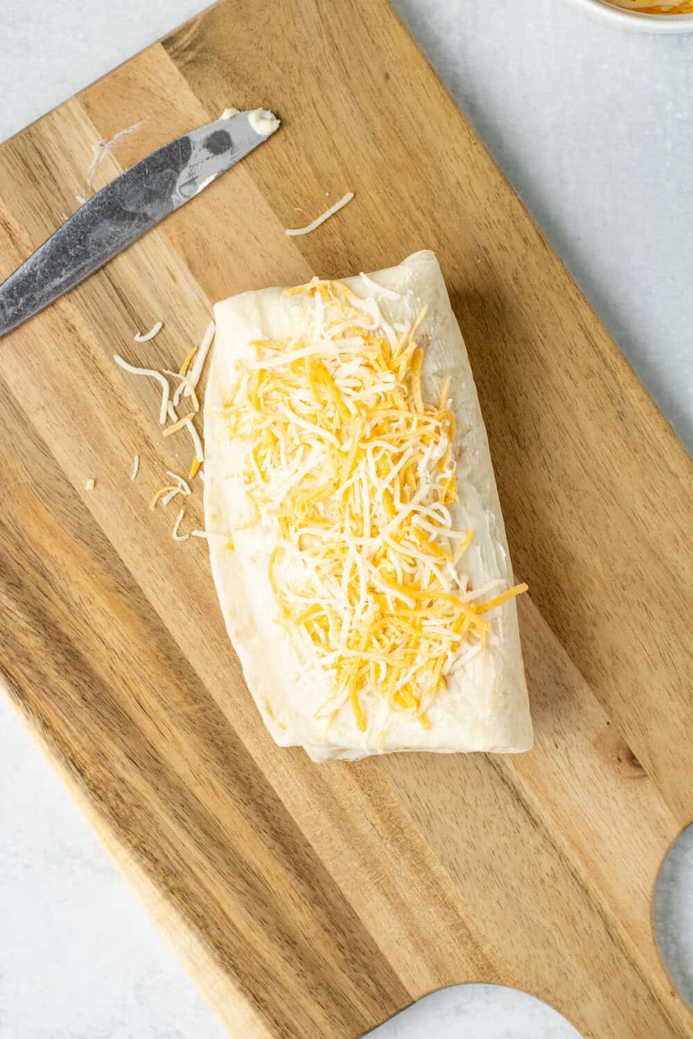 burrito with butter and cheese on top