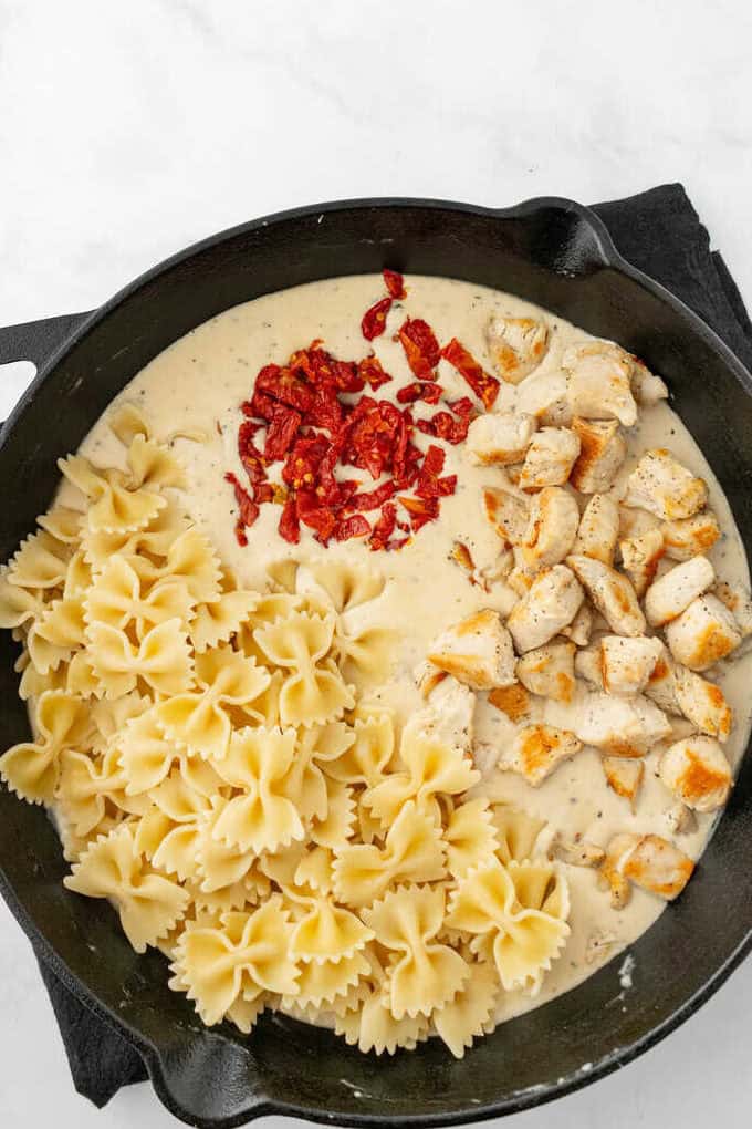sundried tomatoes, pasta, and chicken added to sauce