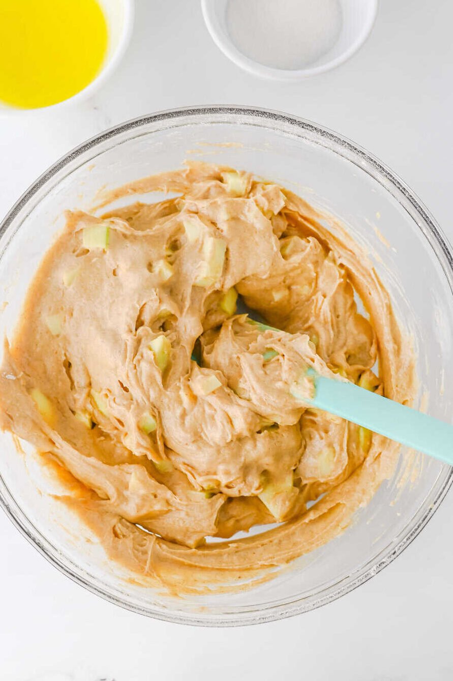 mixing chopped apples into muffin batter