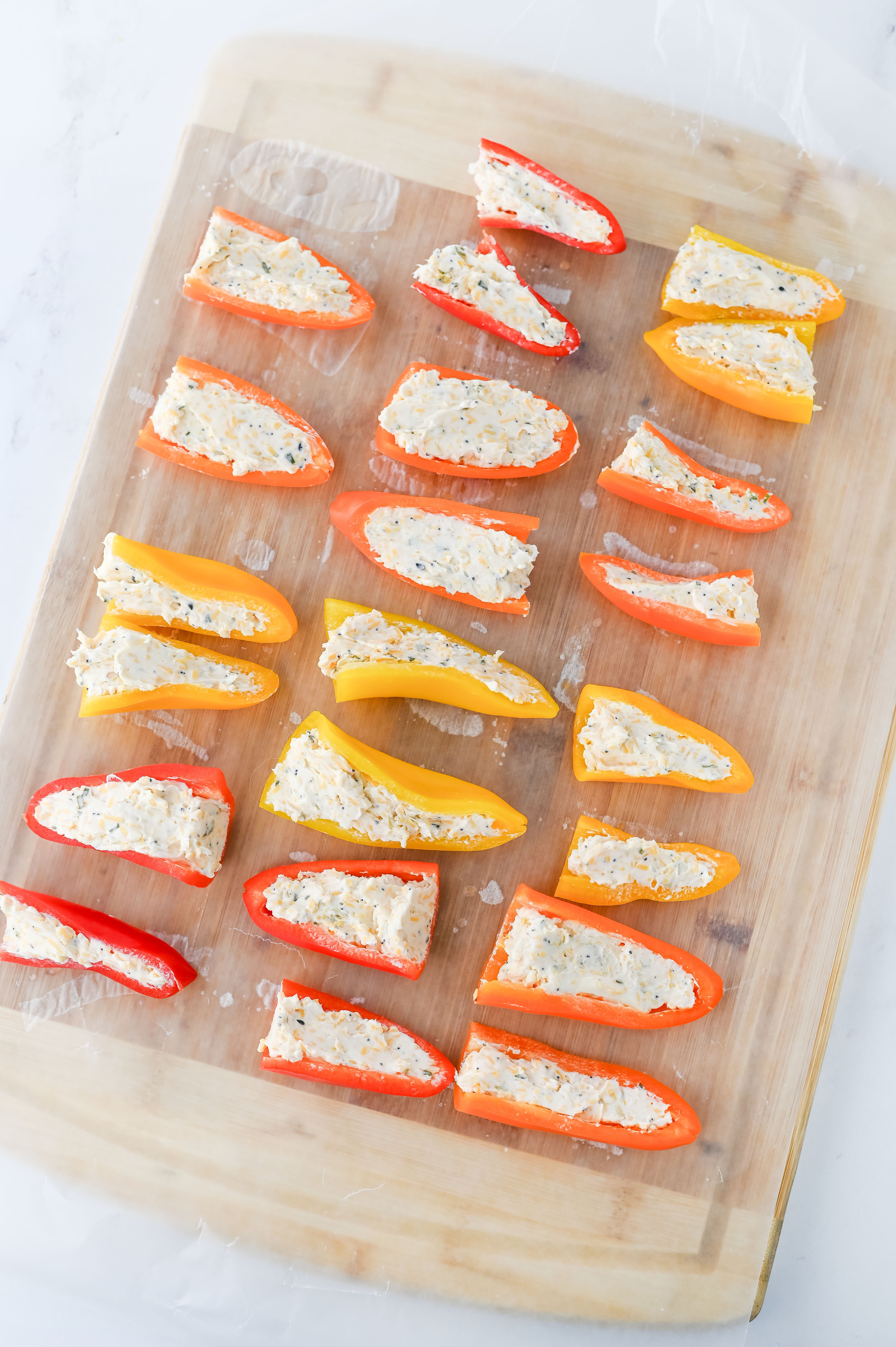 mini sweet peppers cut in half and stuffed with cream cheese filling