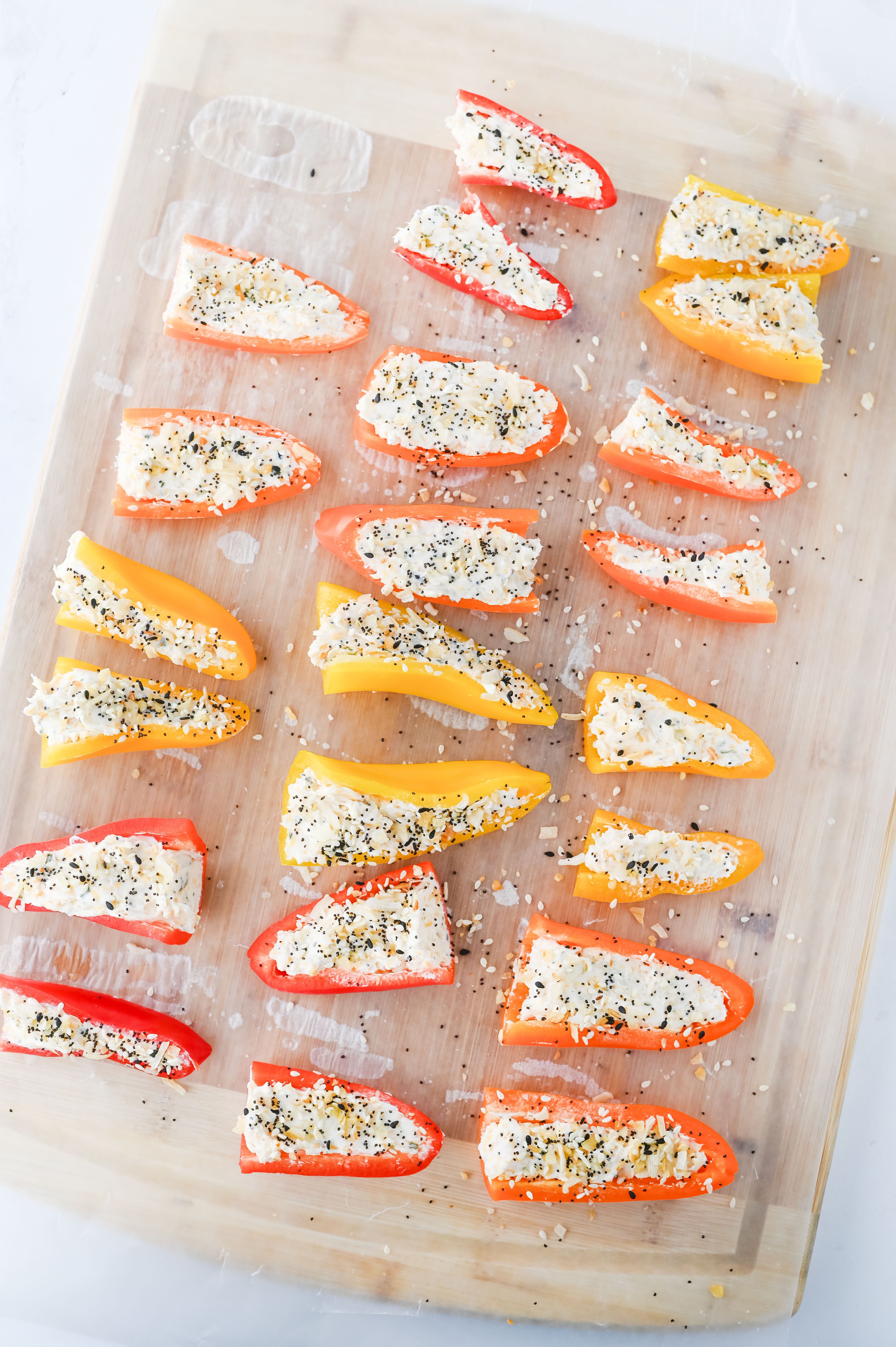 mini sweet peppers cut in half and stuffed with cream cheese filling then sprinkled with Everything Bagel seasoning
