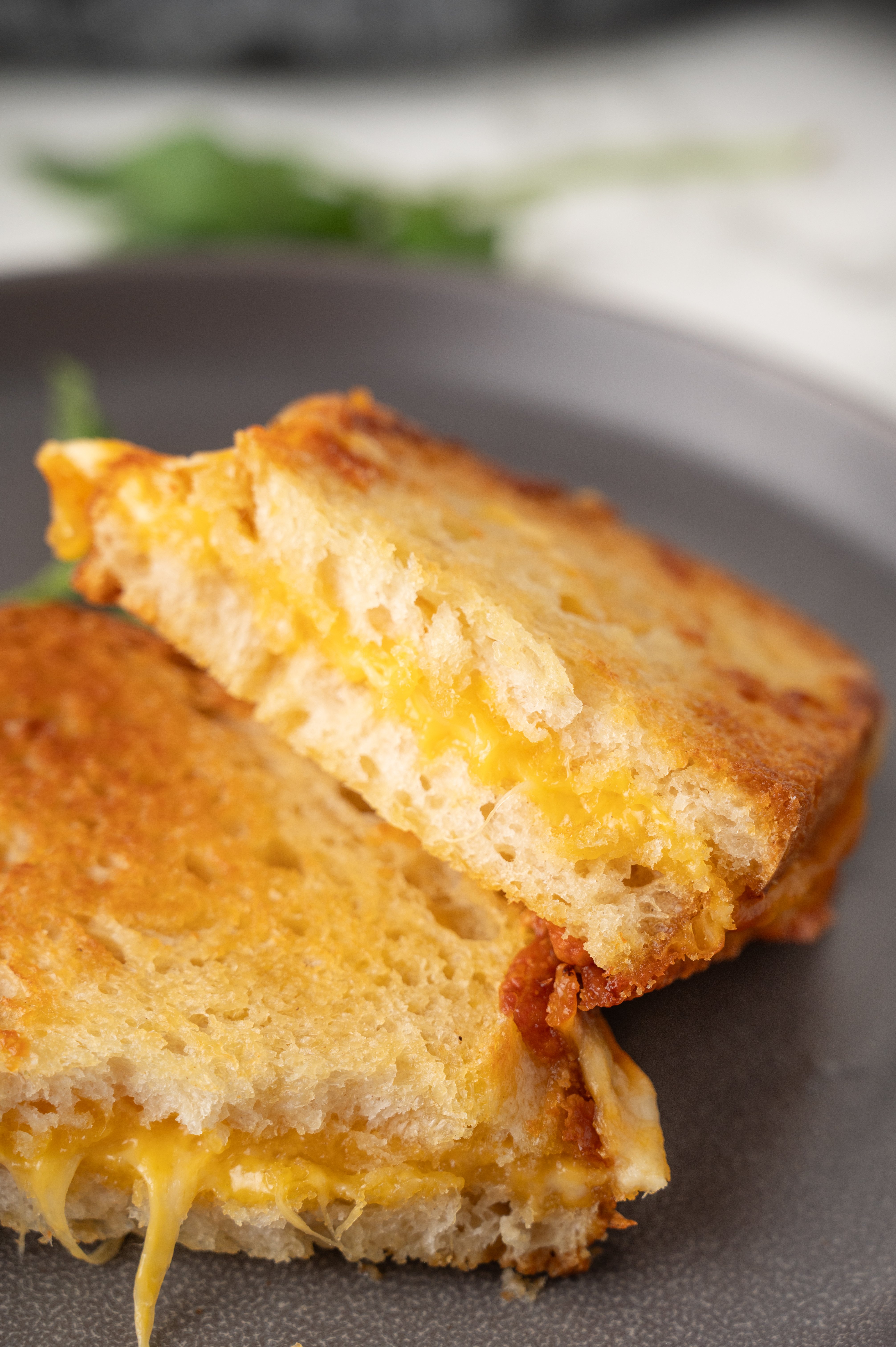 air fryer grilled cheese sandwich cut in half on a plate