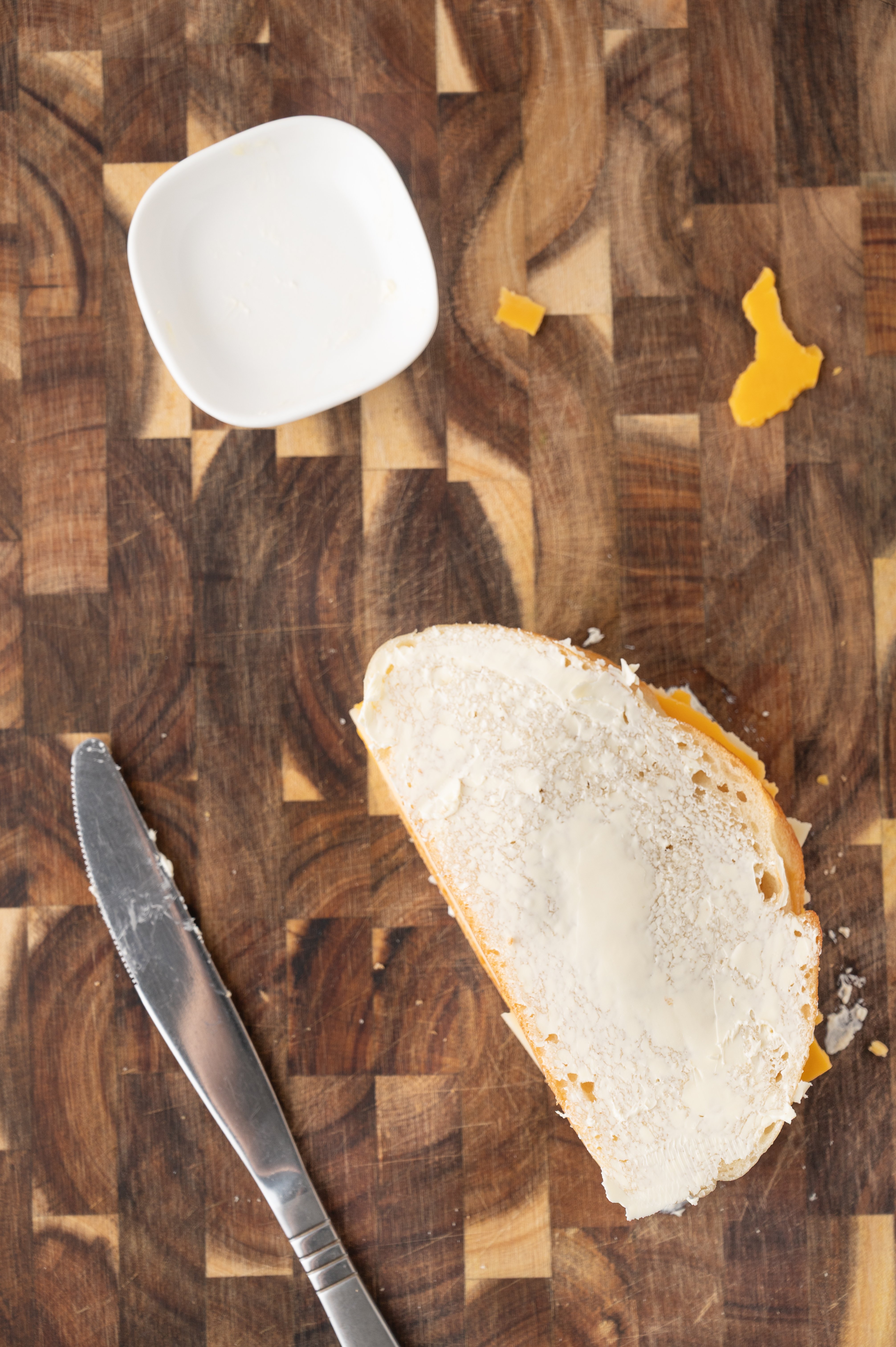 stacked sourdough bread buttered on the outside with slices of cheese in between