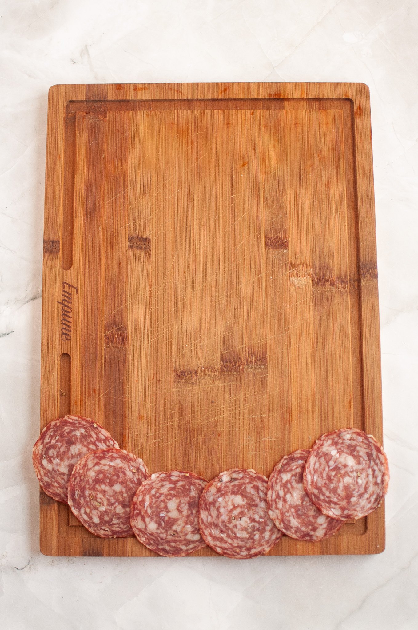 salami across the bottom of a cutting board
