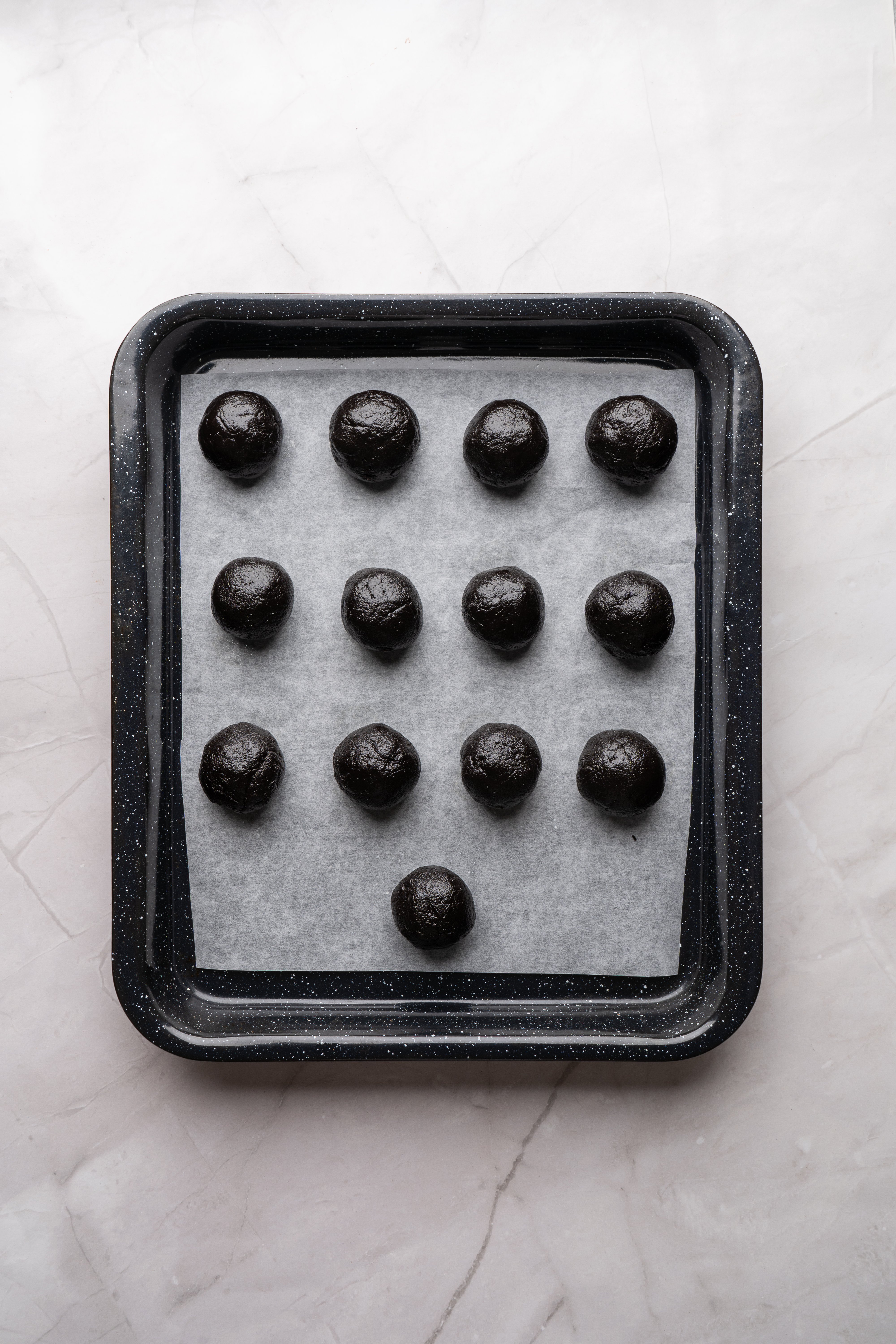 oreo balls on sheet lined with parchment paper