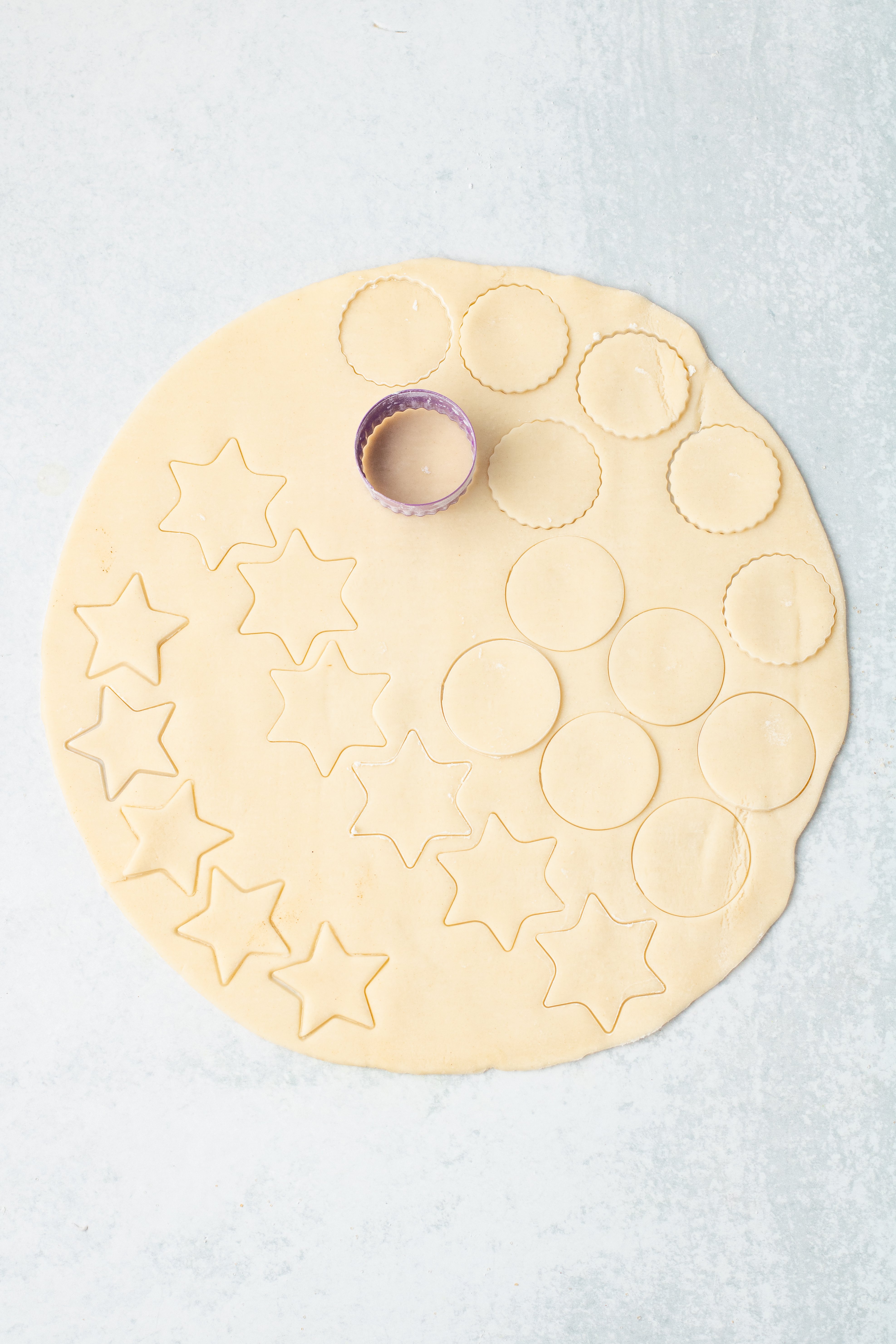 rolled out pie crust cut into shapes with mini cookie cutters