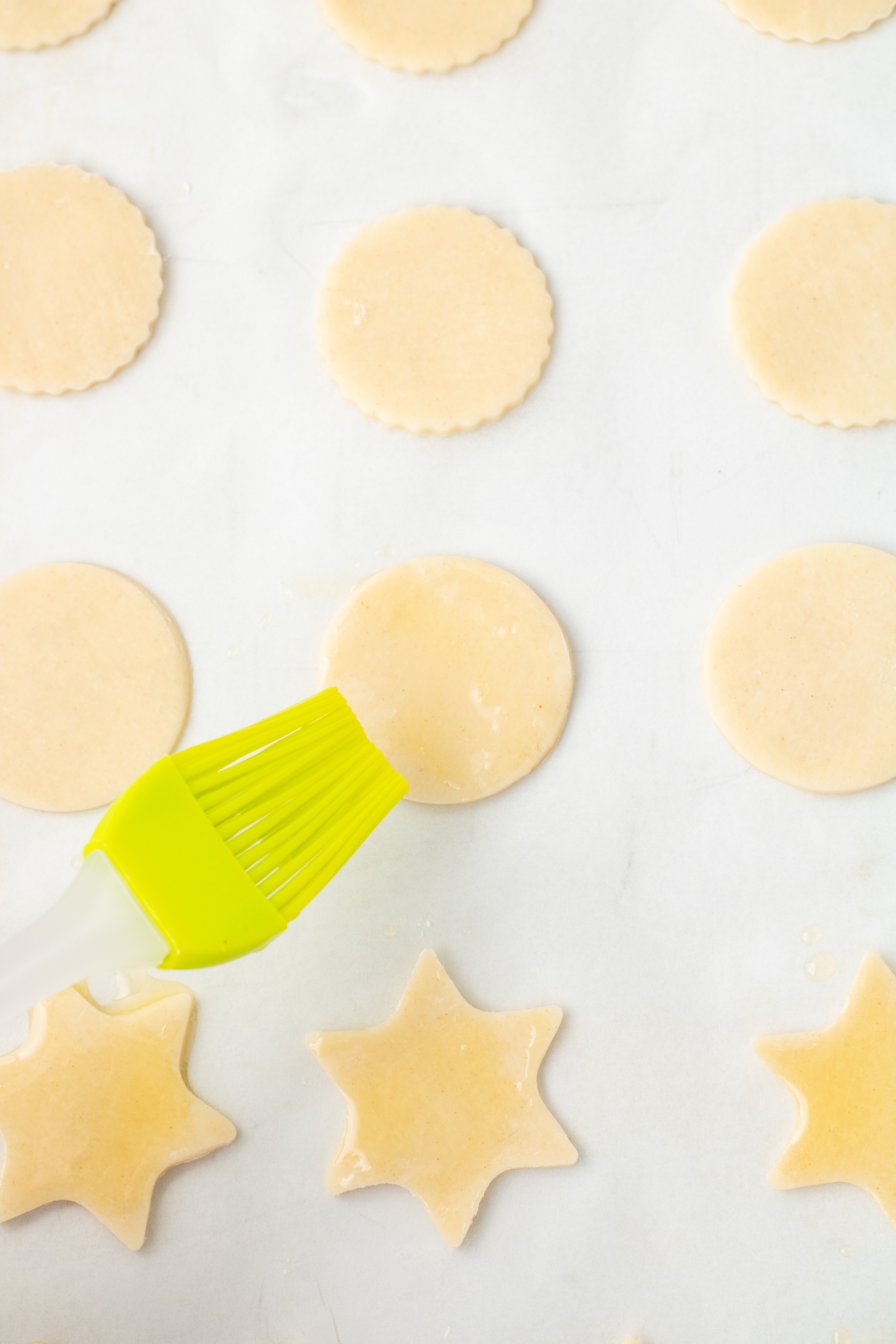brushing pie crust cookies with melted butter