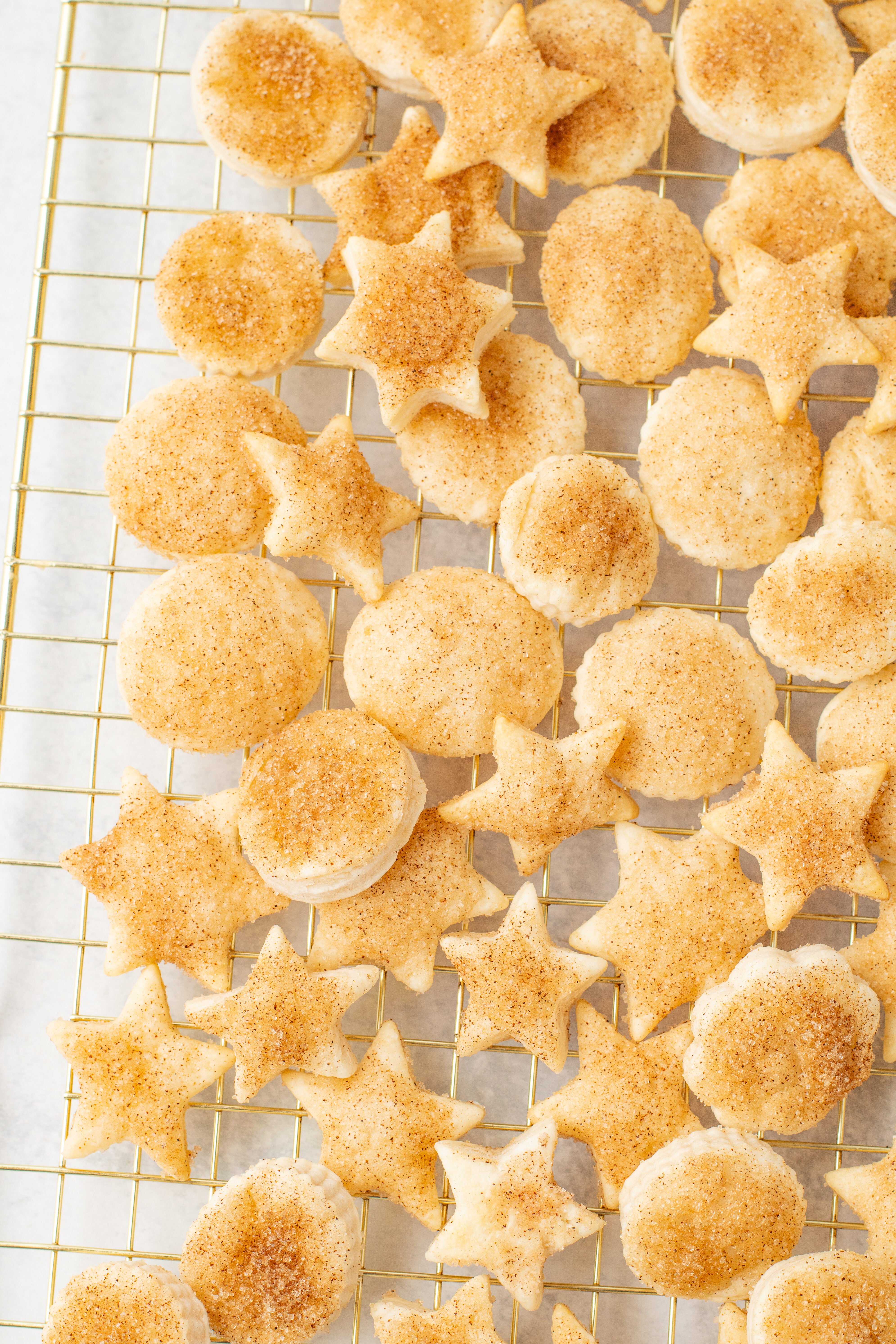 pie crust cookies on a wire rack - cut into circles and stars