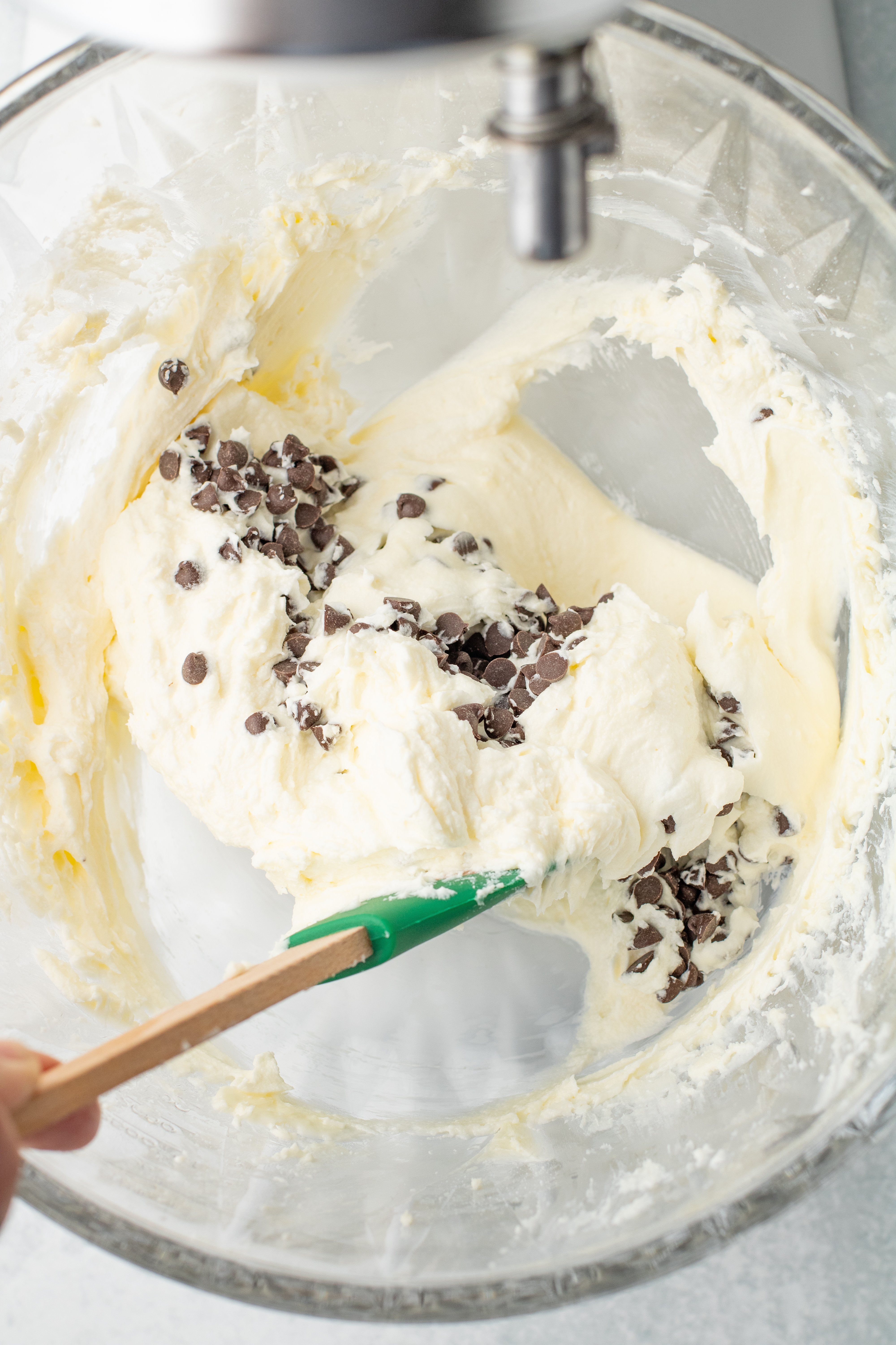 stirring mini chocolate chips into sweet cream cheese dip
