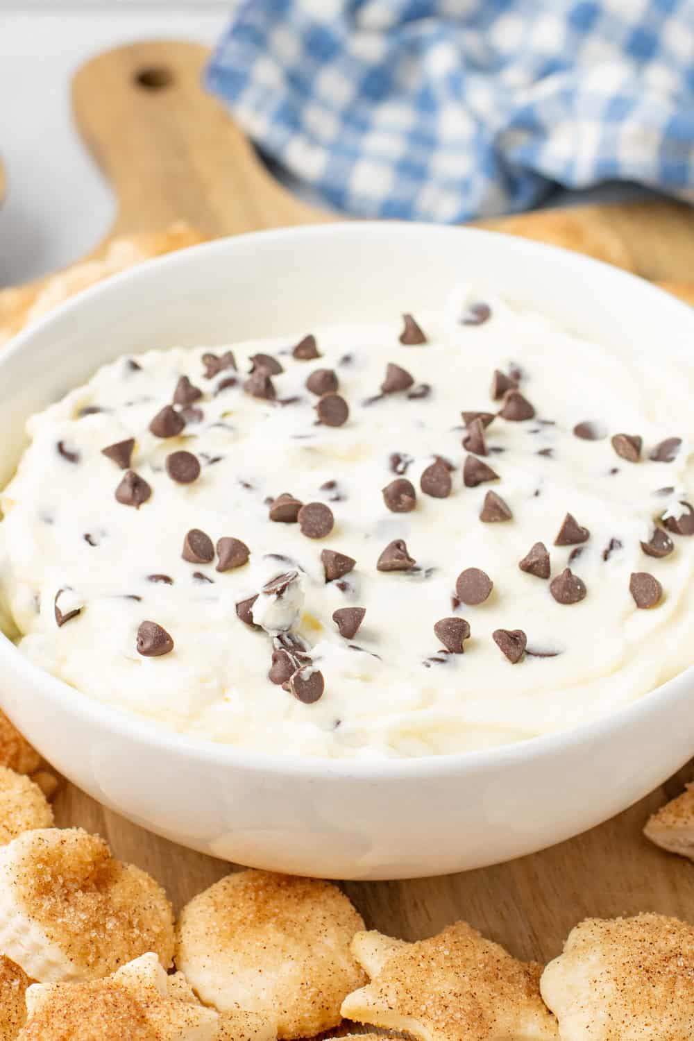chocolate chip dip (cheesecake dip) in a white bowl surrounded by pie crust cookies