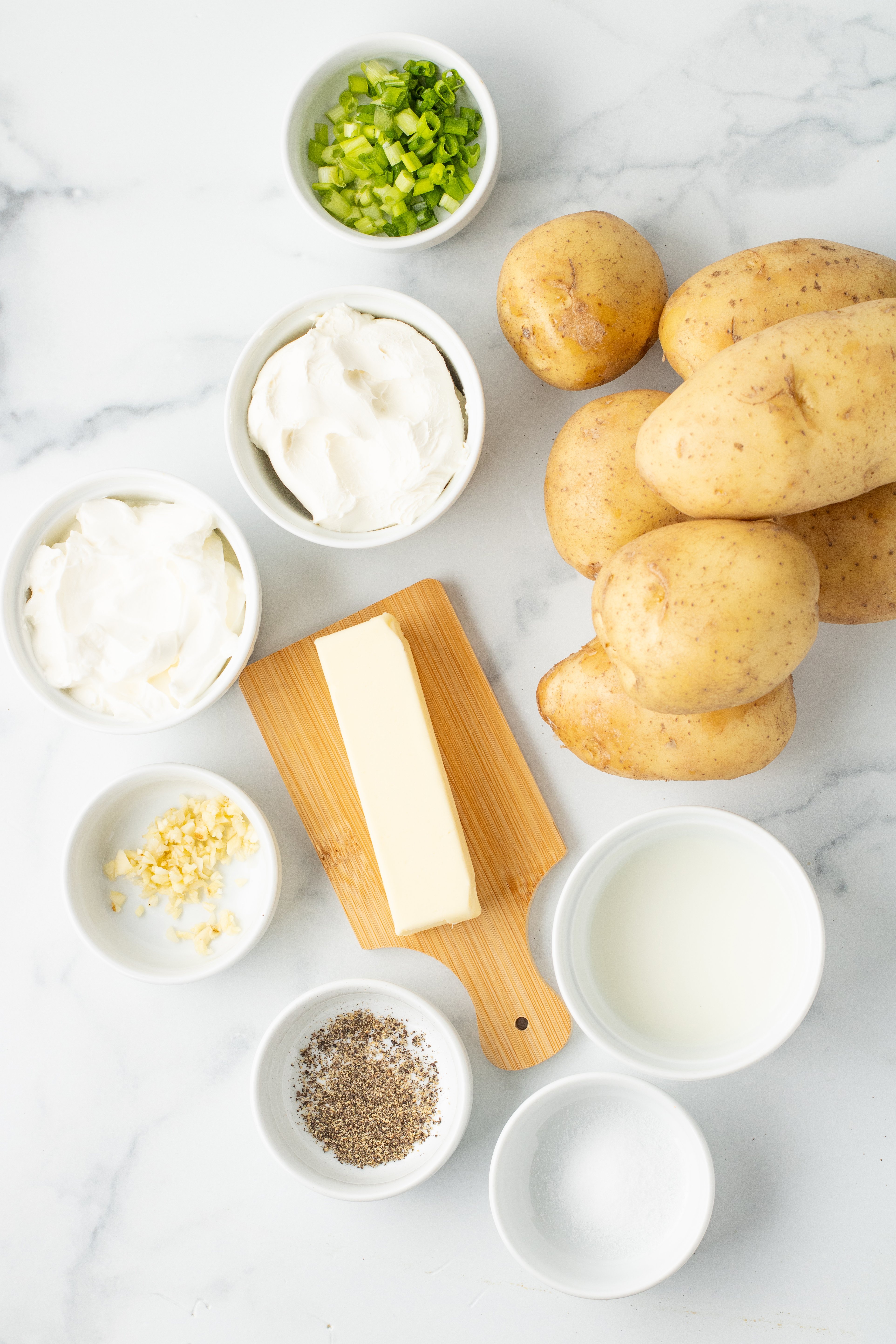 ingredients for cream cheese mashed potatoes in white bowls