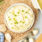 mashed potatoes with cream cheese topped with chives and butter