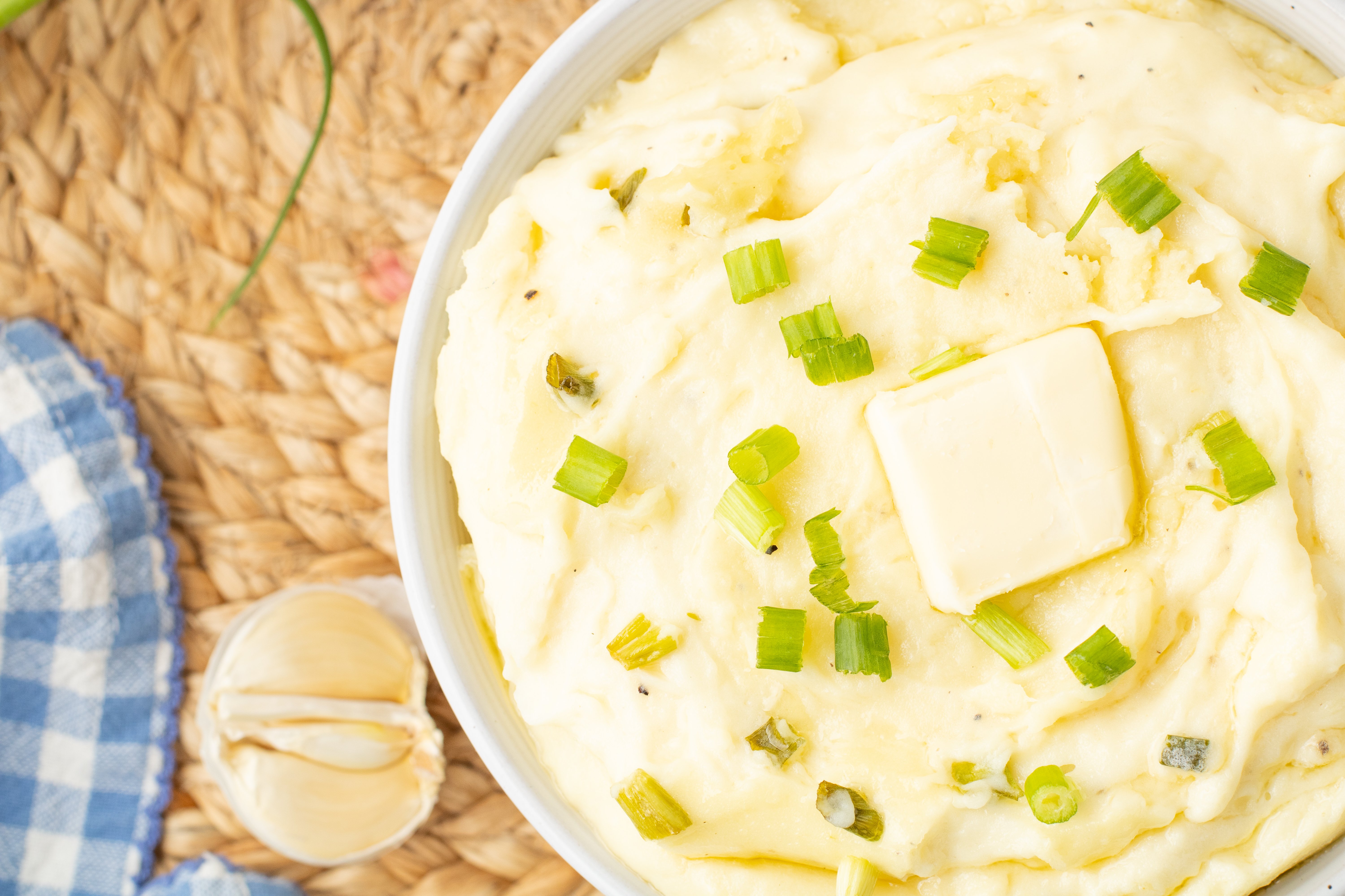mashed potatoes with cream cheese topped with butter and chives
