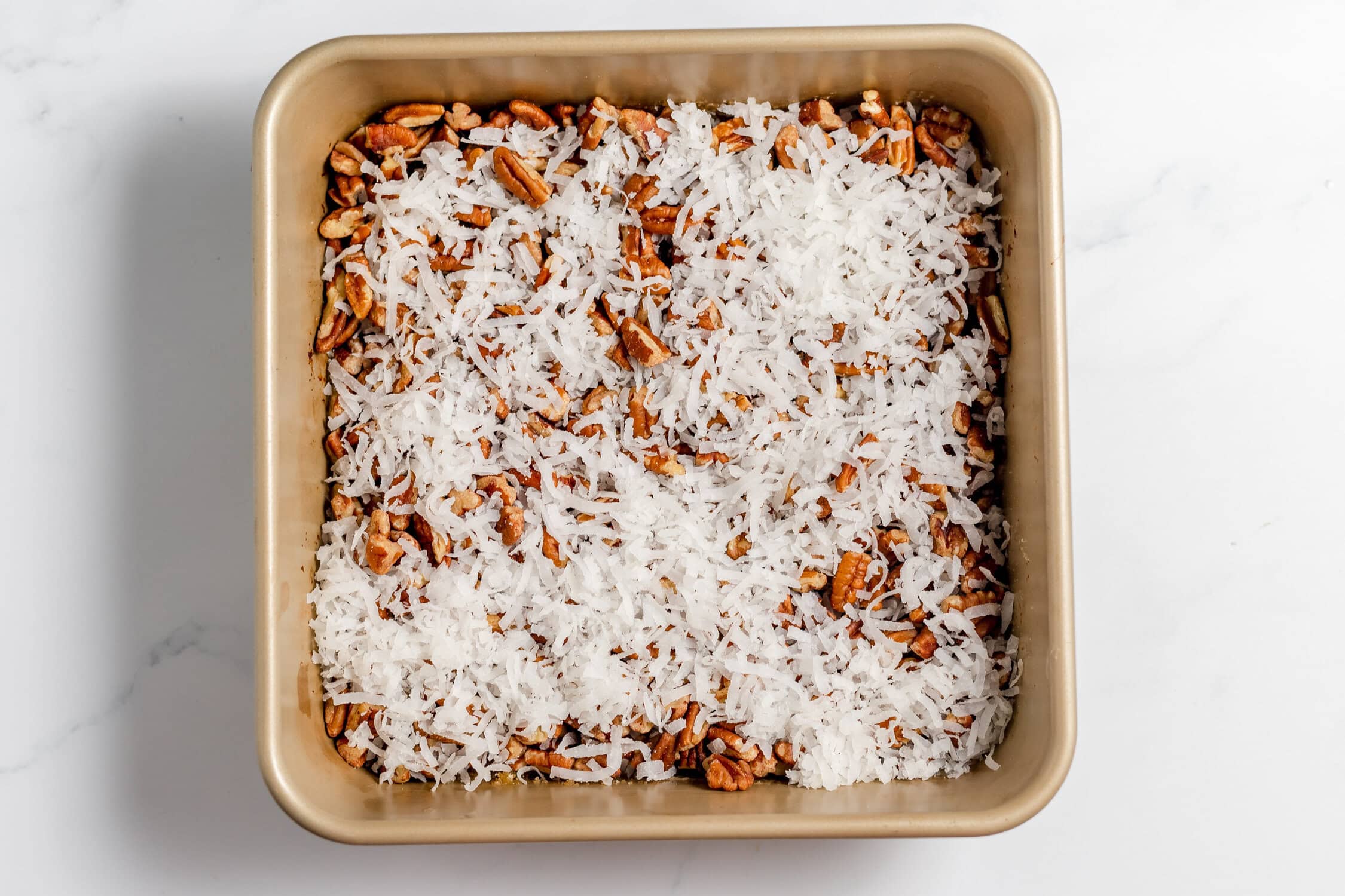 coconut and pecans over the butter in the pan