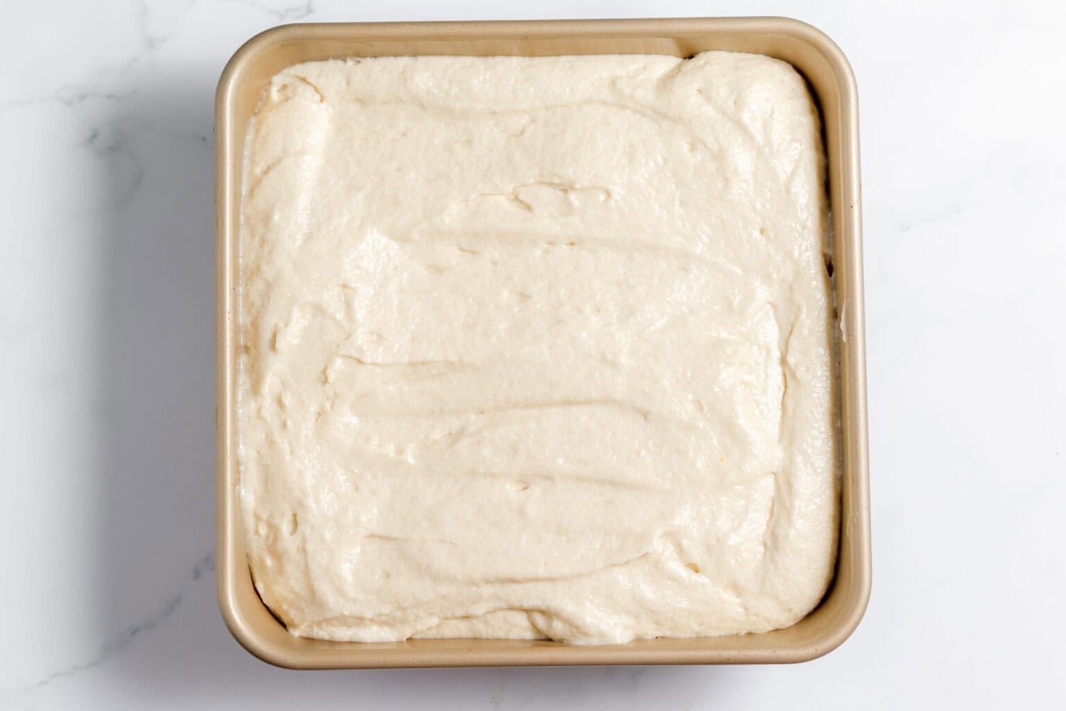batter over pecan mixture in the pan