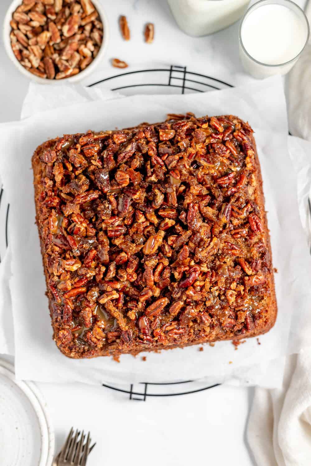 pecan upside down cake on parchment on a cooling rack