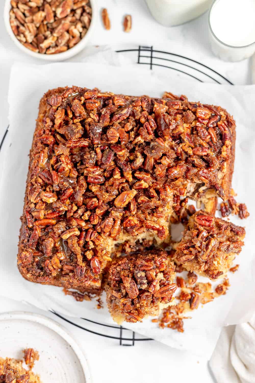 upside down pecan pie cake with a couple of slices cut out (above head shot)