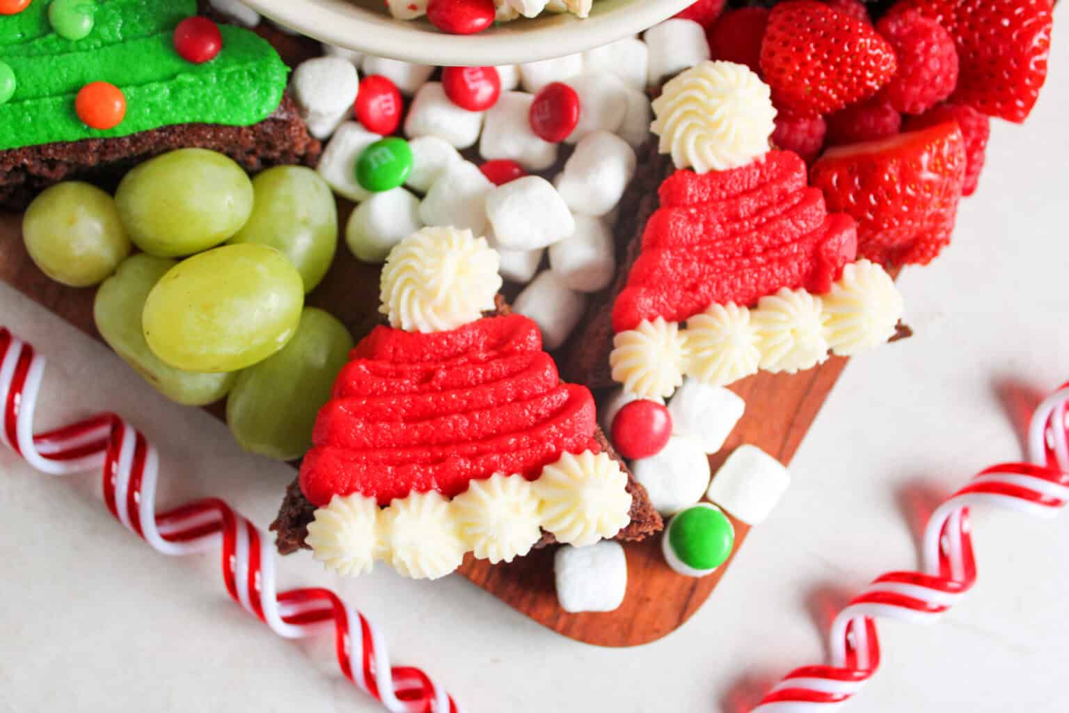 santa hat brownies on a christmas charcuterie dessert board