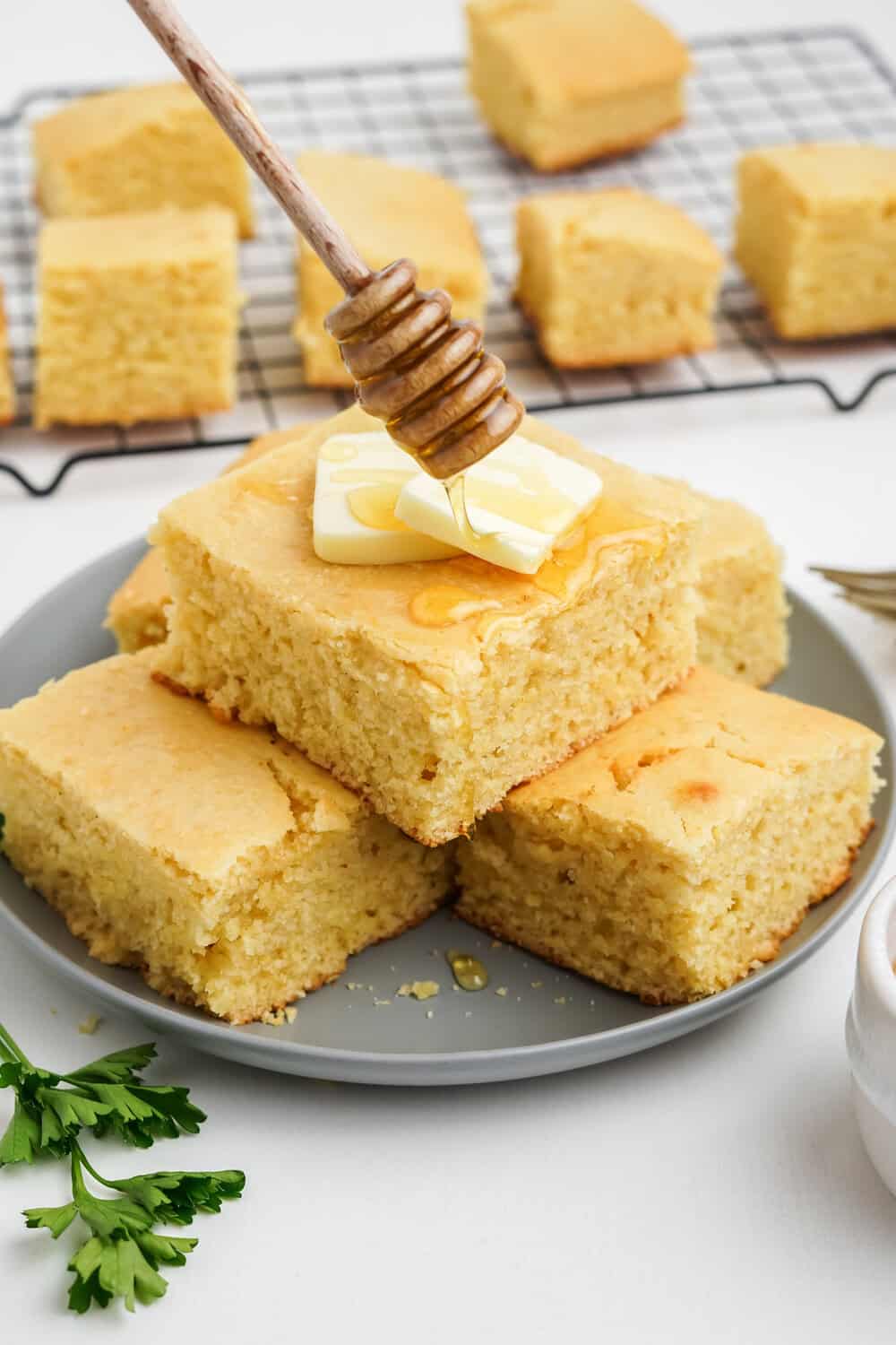 honey cornbread with butter and a drizzle of honey on top