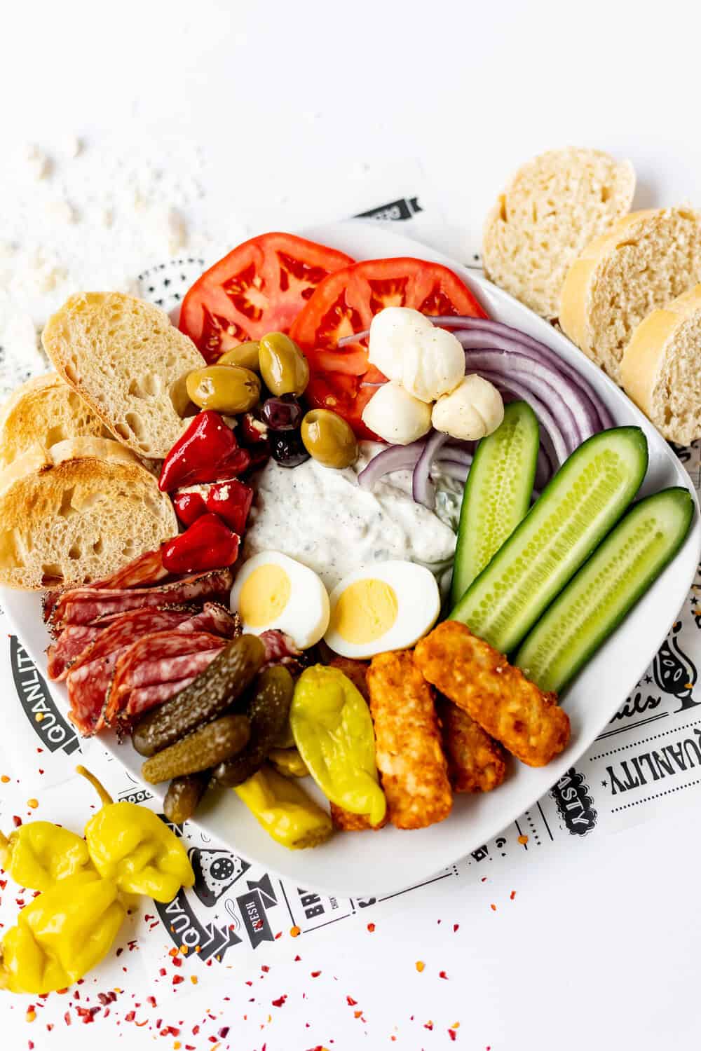 stuffed peppers, pickles, egg, olives, and cheese added to the plate