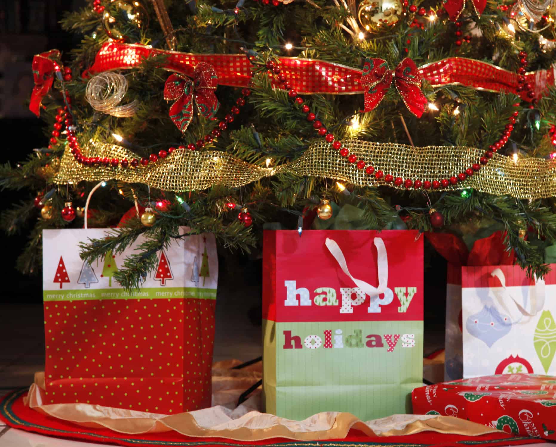 gift bags under a christmas tree