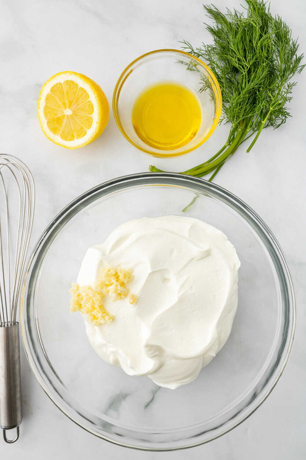 greek yogurt and garlic in a clear bowl