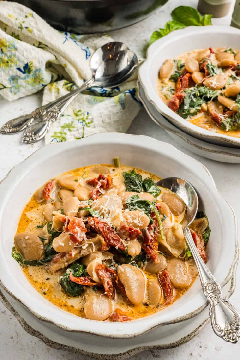 Marry Me Butter Beans in a white bowl with a spoon