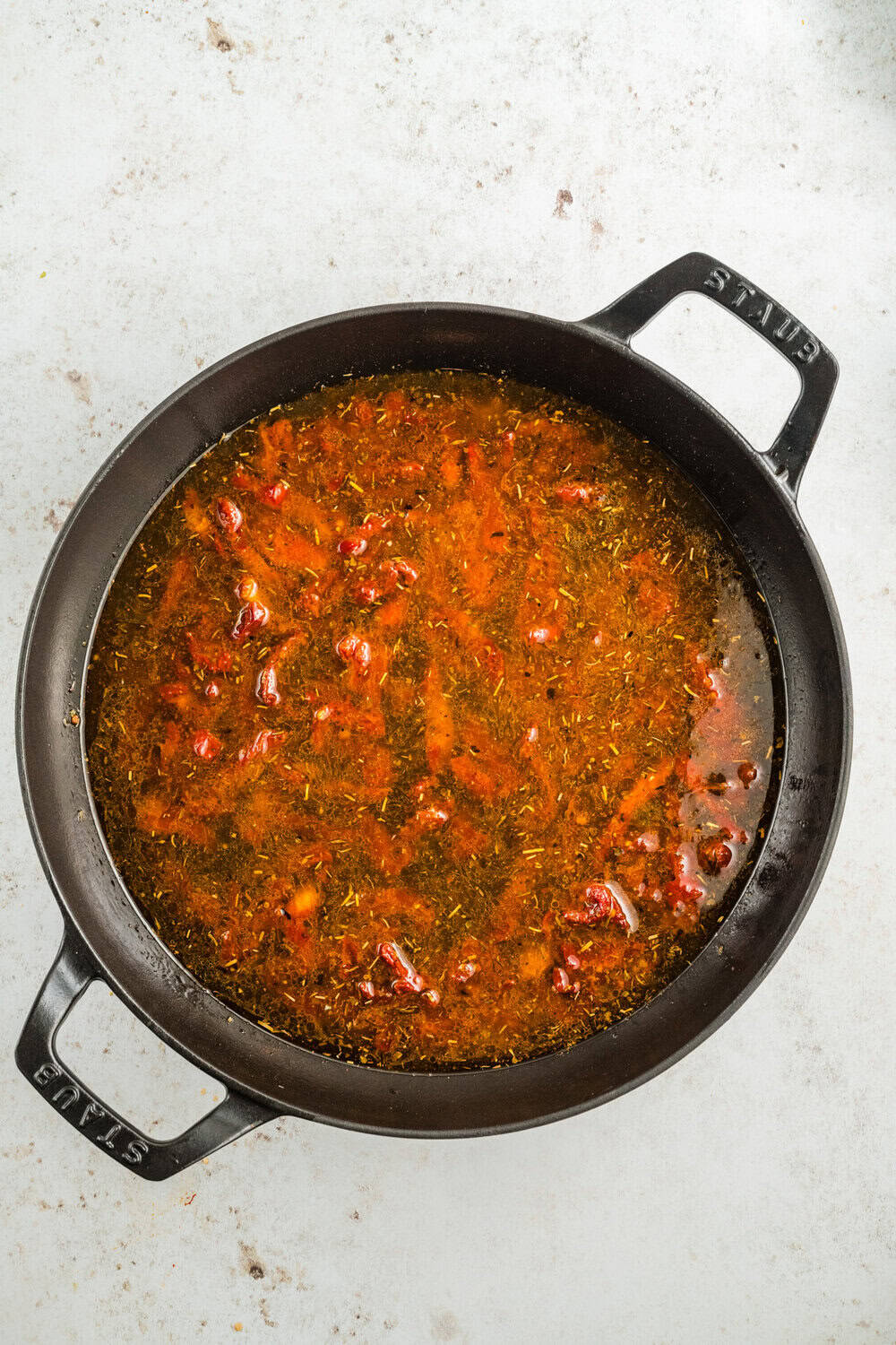 sundried tomatoes and the vegetable broth added to the skillet