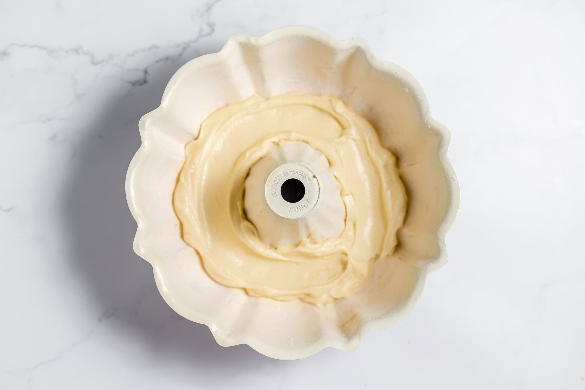 small amount of batter in bottom of bundt pan
