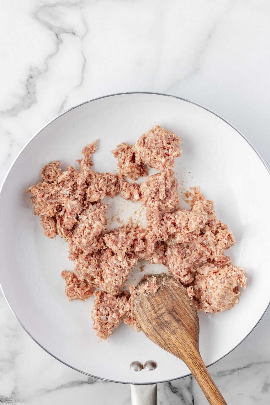 sausage broken into small pieces in a skillet